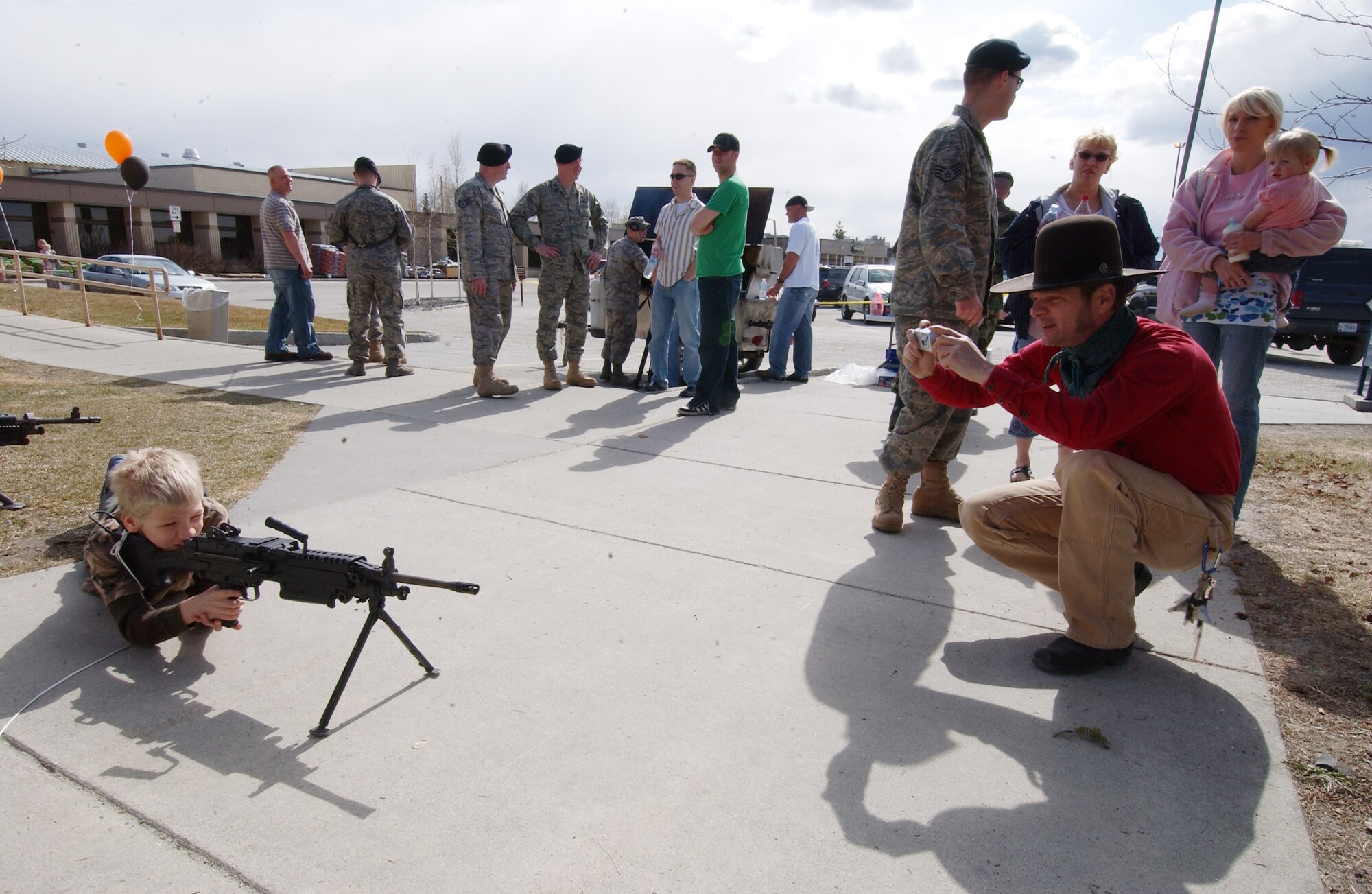 Wyatt Wetherington operates a machine gun while his father Neil Wetherington takes a photo May 13, 2008, at Eielson Air Force Base, Alaska. The 354th Security Forces Squadron hosted events all throughout the week for families and community involvement with displays, demonstrations and games. Police week is designed to honor who are serving and who have served in law enforcement. (U.S. Air Force Photo/Airman 1st Class Jonathan Snyder)