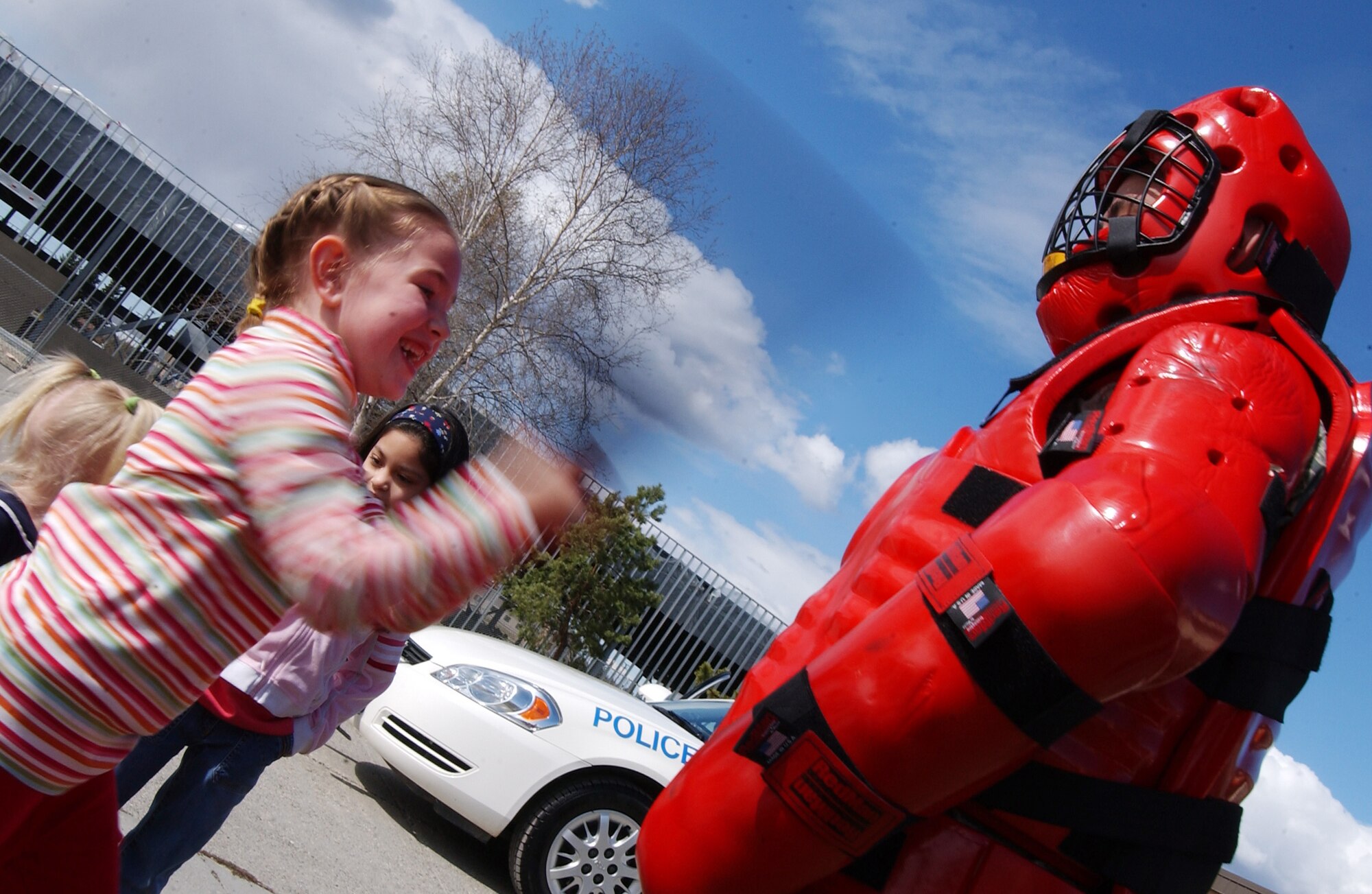 Emily Gregory uses a baton to hit Airman 1st Class Paul Martinez while wearing a red man suit May 13, 2008, at Eielson Air Force Base, Alaska. The 354th Security Forces Squadron hosted events all throughout the week for families and community involvement with displays, demonstrations and games. Police week is designed to honor who are serving and who have served in law enforcement. Emily is the daughter of Maj. Lester Gregory, 354th Operations Group. (U.S. Air Force Photo/Airman 1st Class Jonathan Snyder)