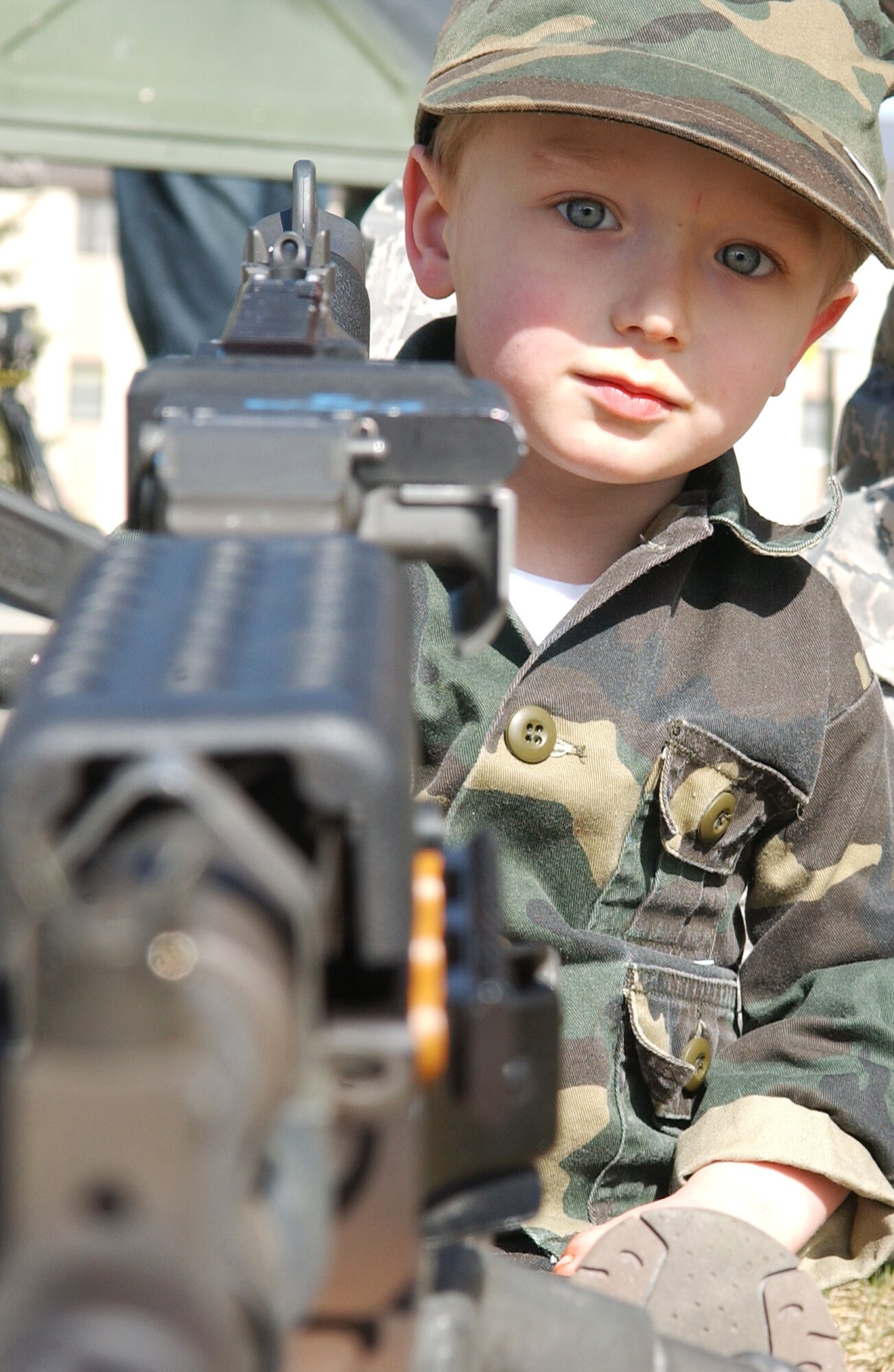 Bradley Summers sits behind an M-240B machine gun May 13, 2008, at Eielson Air Force Base, Alaska. The 354th Security Forces Squadron hosted events all throughout the week for families and community involvement with displays, demonstrations and games. Police week is designed to honor those who are serving and who have served in law enforcement. Bradley is the son of Staff Sgt. Jerry Summers, 354th SFS. (U.S. Air Force Photo/Airman 1st Class Jonathan Snyder)