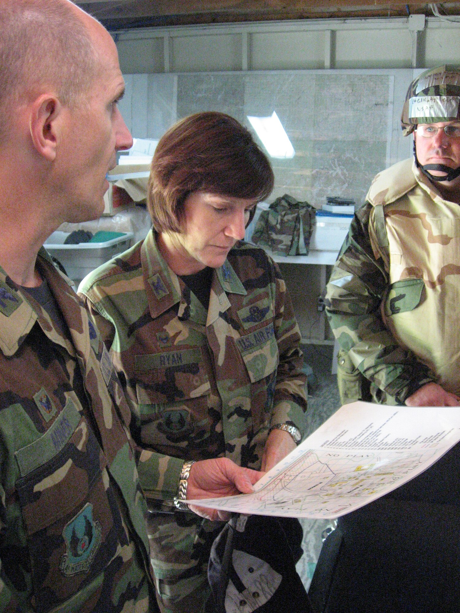 Col. Colleen Ryan, 88th Air Base Wing commander at Wright-Patterson Air Force Base, Ohio, reviews the exercise play area with Col. James Miner (left), 88th Mission Support Group commander, and Lt. Col. Scott Katz, 88th Mission Support Group deputy commander.  Katz commanded a group of base Airmen simulated deployed to a forward operating location where they were subjected to conventional and chemical attacks.  (U.S. Air Force photo/Derek Kaufman)