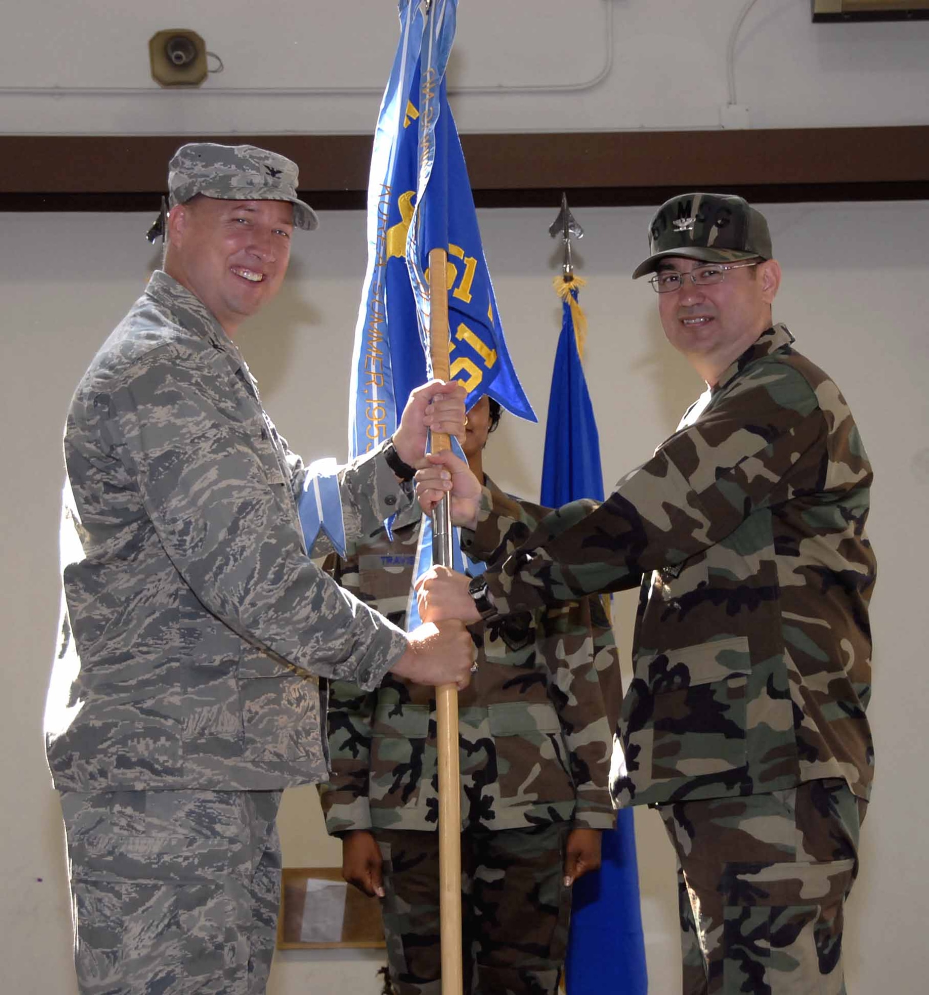 Col. Roland Van Deventer, (right), accepts command of the 51st Mission Support Group from Col. Jon Norman, (left), during a ceremony Tuesday. Colonel Van Deventer had been the 51st MSG’s military deputy commander since his arrival in 2007. (U.S. Air Force photo/Staff Sgt. Scottie McCord)