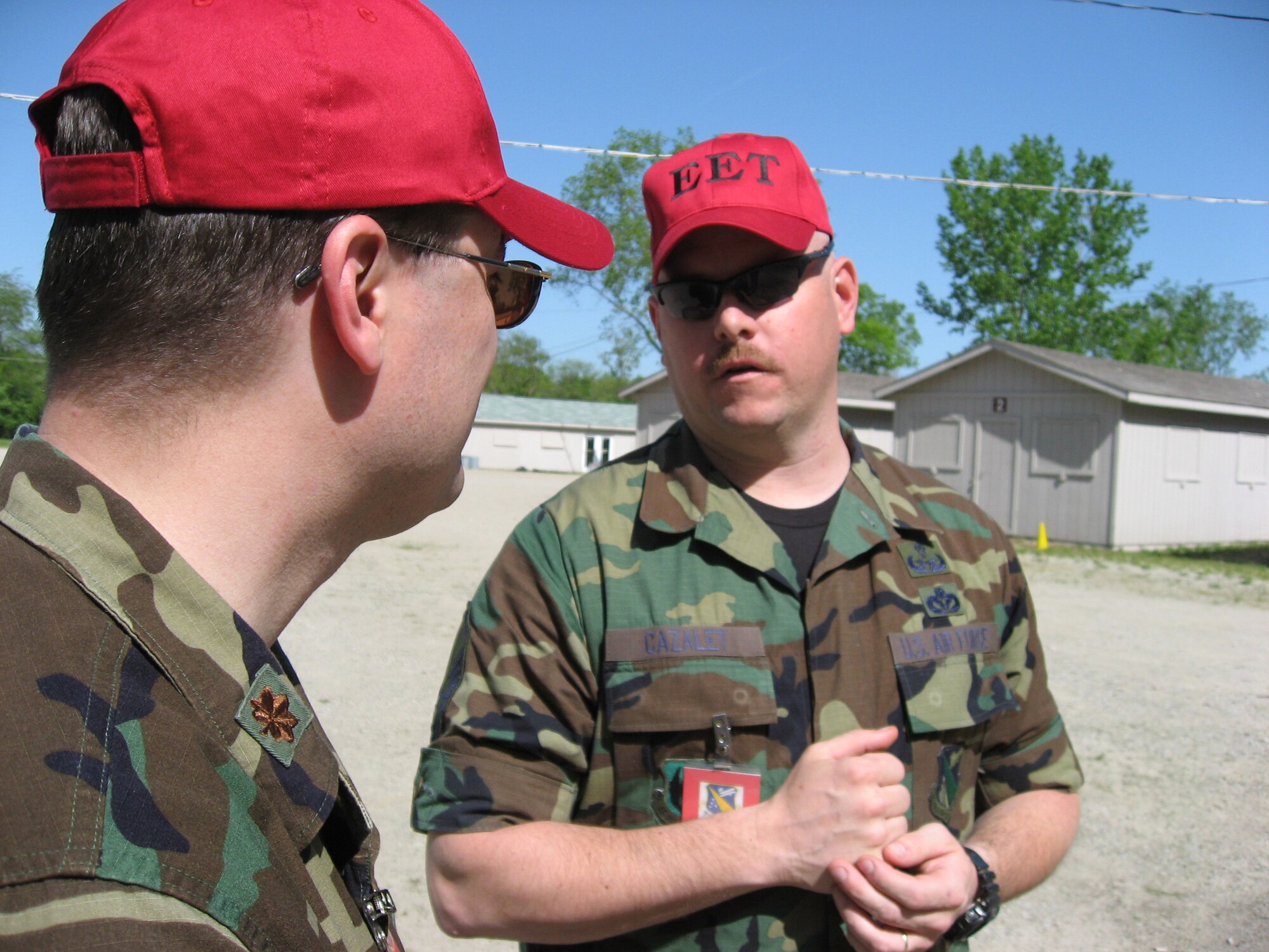 Maj. Jason Jackson, chief of the Installation Exercise Program Office, 88th Air Base Wing (left), and Master Sgt. Patrick Cazalet, chief, Explosive Ordnance Disposal Division, 88th Civil Engineer Directorate, discuss an inject during an employment exercise May 13 at Wright-Patterson Air Force Base.  The exercise is part of ongoing pre-deployment training and the base's preparations for the March 2009 Operational Readiness Inspection. (U.S. Air Force photo/Derek Kaufman) 