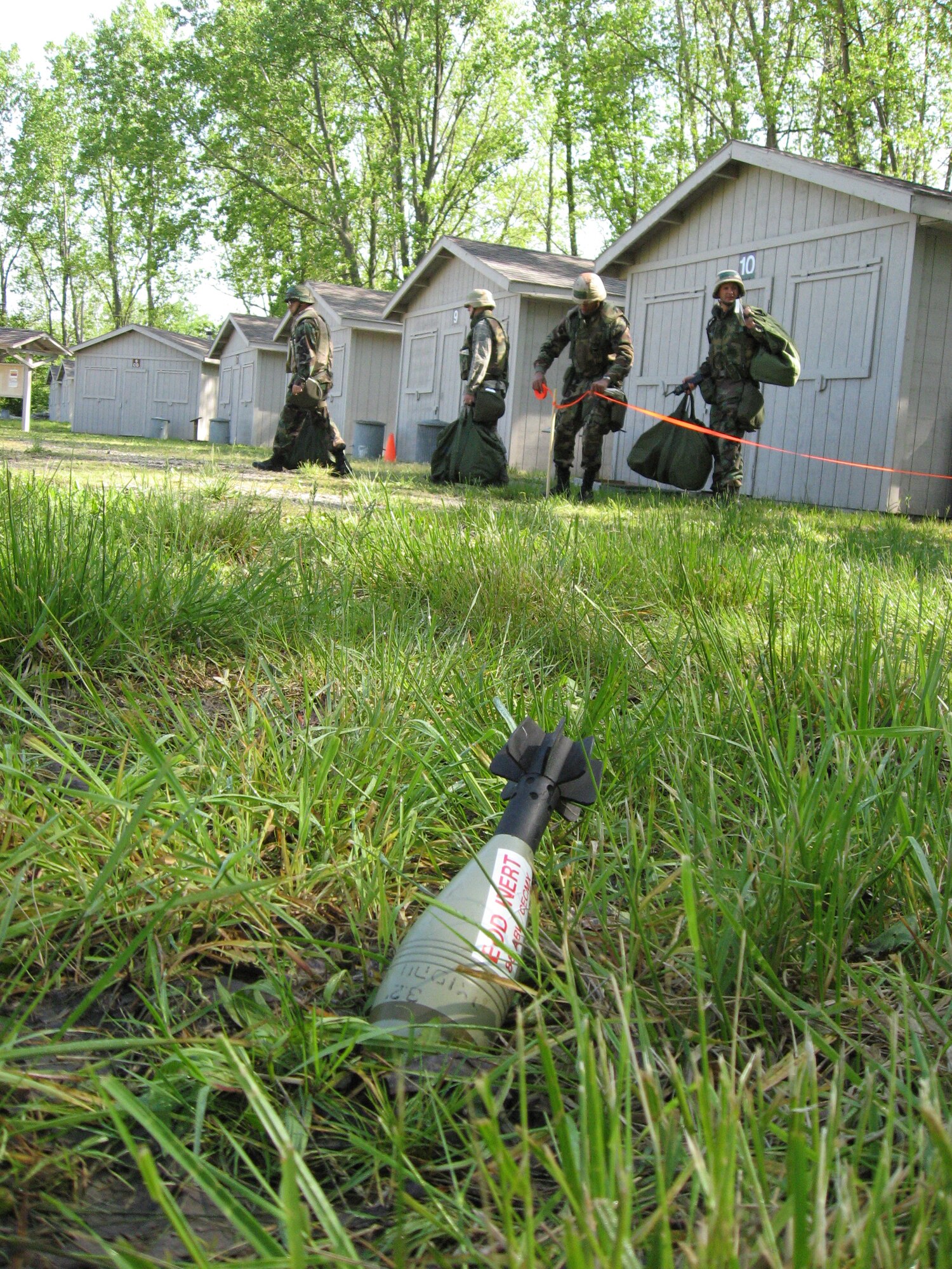Airmen evacuate a building and mark off unexploded ordnance during an operational employment readiness exercise at Wright-Patterson Air Force Base, Ohio. The exercise evaluated base-level command and control and defense against conventional and chemical attacks.  (U.S. Air Force photo/Derek Kaufman)