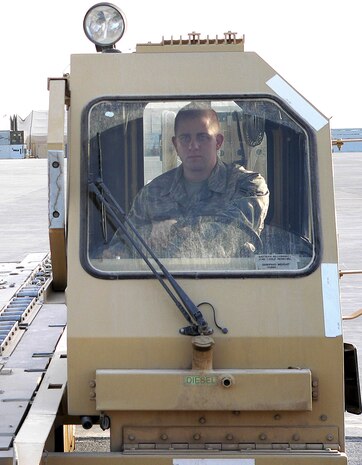 Airman 1st Class Adam Bourquin loads cargo onto a C-17 Globemaster. (courtesy photo)