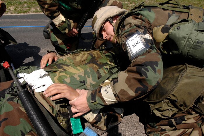 Staff Sgt. Ian Ouellette, simulates providing medical aid to a fellow Airman during Operation Crisis Reach an operational readiness exercise held at Alpena, Mich., May 5.  Sergeant Ouellette is assigned to the 437th Logistics Readiness Squadron. (U.S. Air Force photo/Staff Sgt. Shawn Weismiller)