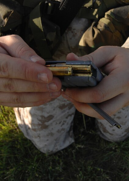 MINERAL WELLS, Texas -- M-16 rounds are placed into a magizine  May 9, 2008. Marines must first adjust the front site and rifle sling before actually starting their qualifications, this helps better their chances to acquire expert. (U.S Air Force photo by Airman 1st Class Jennifer Romig)
