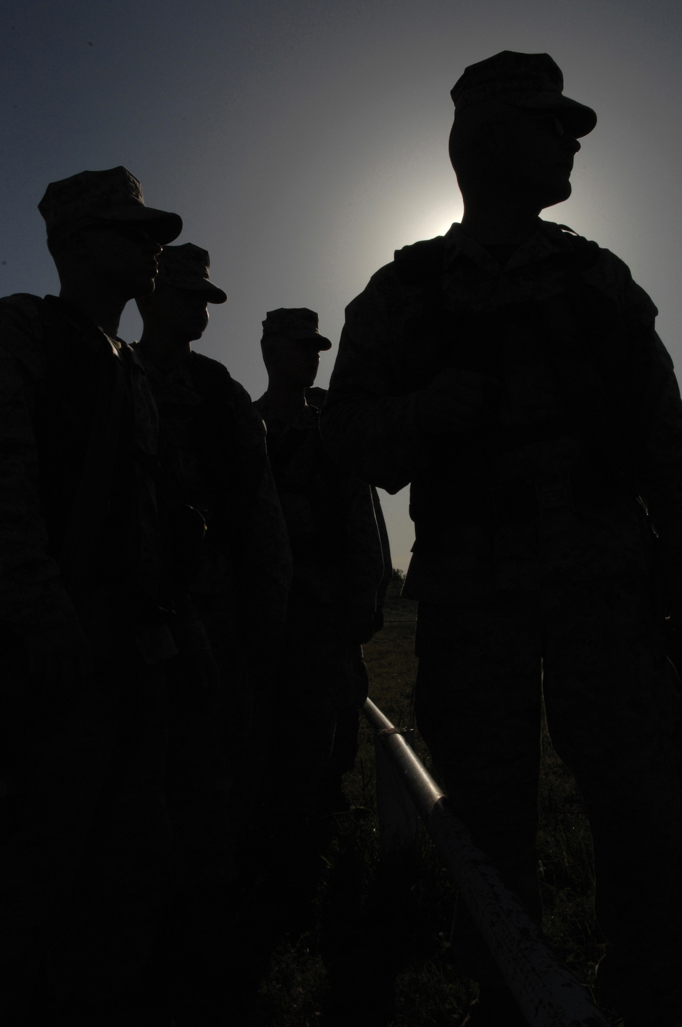 MINERAL WELLS, Texas -- Staff Sgt. Forrest Breeden and fellow Marines watch as their a group of Devil Dogs start zeroing their weapons May 9, 2008. Before shooting their M-16s the Marines BZO their weapons, which is adjusting the front site to better align their shots. (U.S Air Force photo by Airman 1st Class Jennifer Romig)