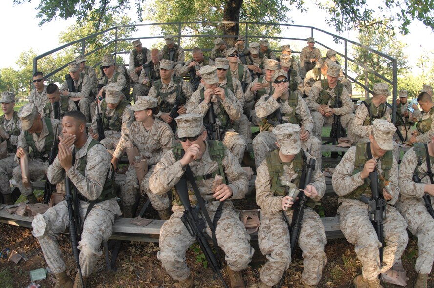MINERAL WELLS, Texas -- Marines from Detachment 1 Motor T Maintenance Company, eat their breakfast MREs May 9, 2008. Det. 1 spent a weekend at the rifle range in Mineral Wells to complete their M-16 annual qualifications. The Devil Dogs endured temperatures that peeked 96 degrees in the field with no shade,  all of the Marines qualified marksman or better. (U.S Air Force photo by Airman 1st Class Jennifer Romig) 