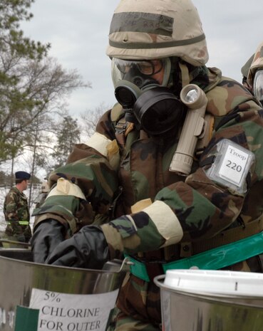Chief Master Sgt. Denise Mikolajczyk moves through a transition control point May 6 after a chemical attack exercise. TCPs divide the base into multiple sectors or control zones that have different Mission Oriented Protective Postures for each area. Chief Mikolajczyk is the superintendent of the 437th Force Support Squadron. (U.S. Air Force photo/Master Sgt. Paul Kilgallon)