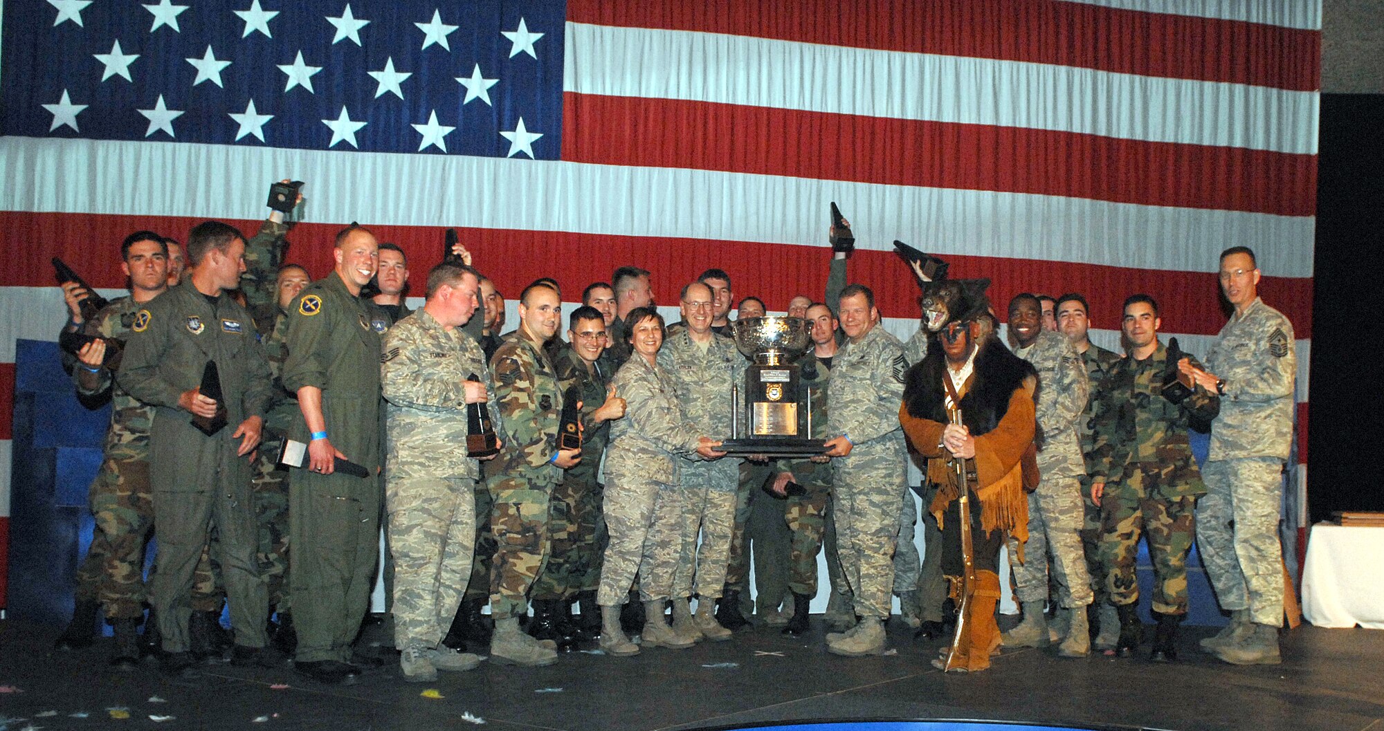 Gen. C. Robert Kehler, Air Force Space Command commander, Col. Sandy Finan, 341st Space Wing commander and Chief Master Sgt. Steve Sargent, 341st Space Wing command chief, hold the Blanchard Trophy, the final award presented May 9 during the awards ceremony for Guardian Challenge. They are surrounded by the rest of Team Malmstrom. AFSPC Command Chief Chief Master Sgt. Todd Small is at the far right. (U.S. Air Force photo/ Tech. Sgt. Matt Lohr)
