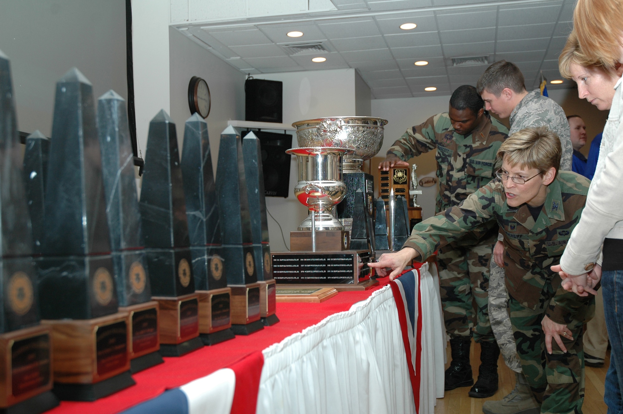 Col. Deborah Kirkhuff, 341st Missile Maintenace Group commander, and other members of Team Malmstrom, admire the stage filled with awards following the Guardian Challenge return and awards presentation at the Grizzly Bend Club Monday. The Blanchard, Blackburn, Moorman and Williams trophies were present, along with 55 other individual awards and trophies won by Team Malmstrom members at Guardian Challenge 2008. (U.S. Air Force photo/Airman 1st Class Emerald Ralston)