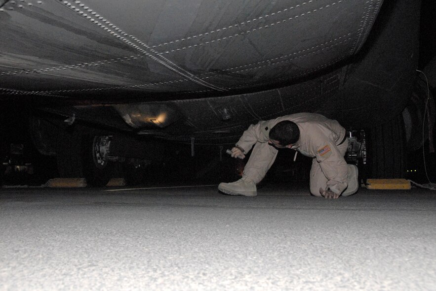 SOUTHWEST ASIA -- Staff Sgt. James Rice, an Air Force C-130 Hercules engineer deployed with the 737th Expeditionary Airlift Squadron at an air base in the Persian Gulf Region performs a pre-flight walk-around of  the aircraft prior to a leaflet airdrop mission over Iraq in May 2008. Sergeant Rice is deployed from Dyess Air Force Base, Texas. (U.S. Air Force photo/Tech. Sgt. Michael O’Connor)