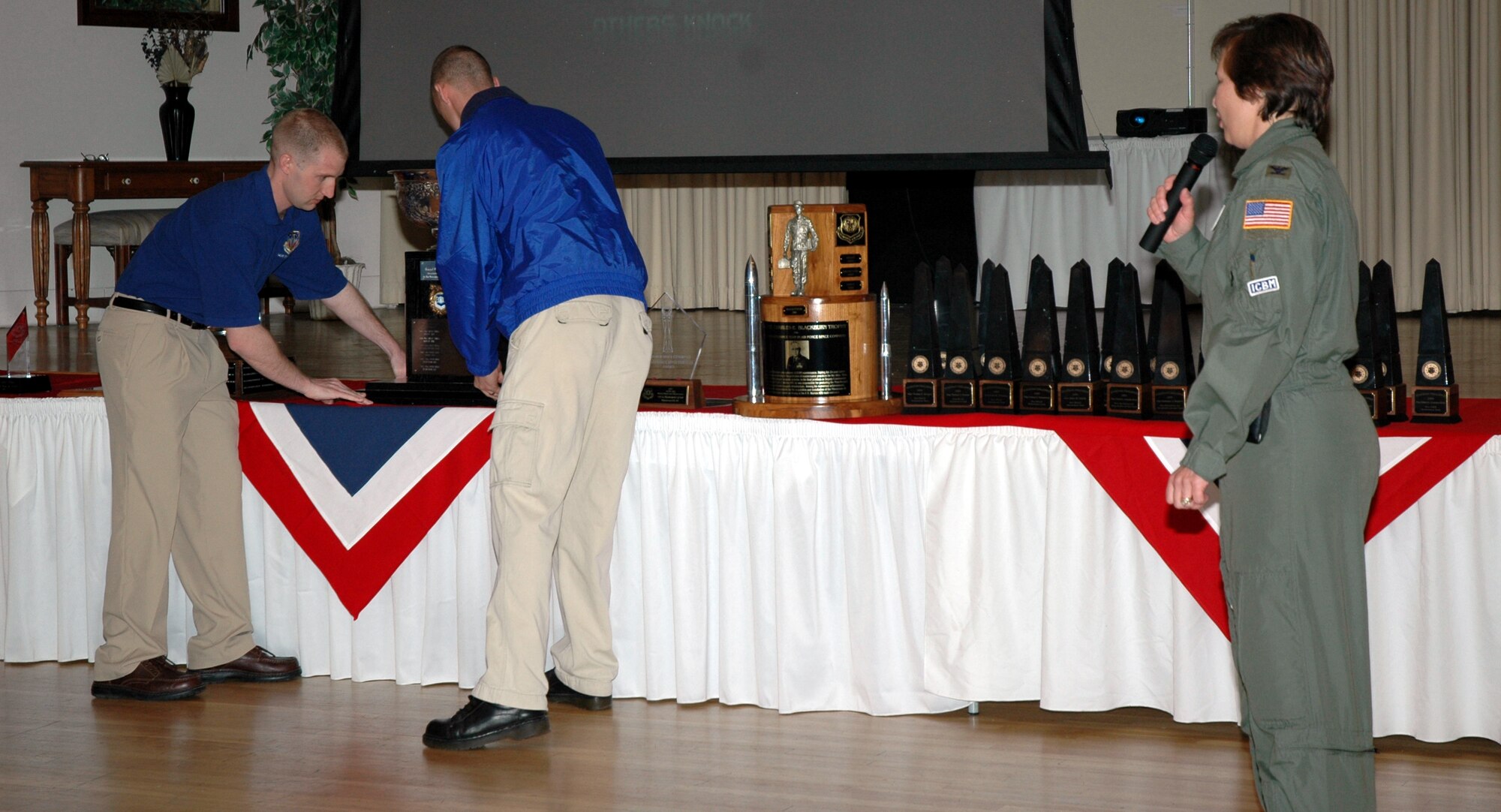 Members of the Guardian Challenge team set the Blanchard Trophy on the stage along with the dozens of other awards and trophies earned by Team Malmstrom at this year's Guardian Challenge competition at Peterson Air Force Base, Colo.  Col. Sandy Finan, 341st Space Wing commander, looks on. Malmstrom took home all but three of the awards they were eligible for this year. (U.S. Air Force photo/Airman 1st Class Emerald Ralston)