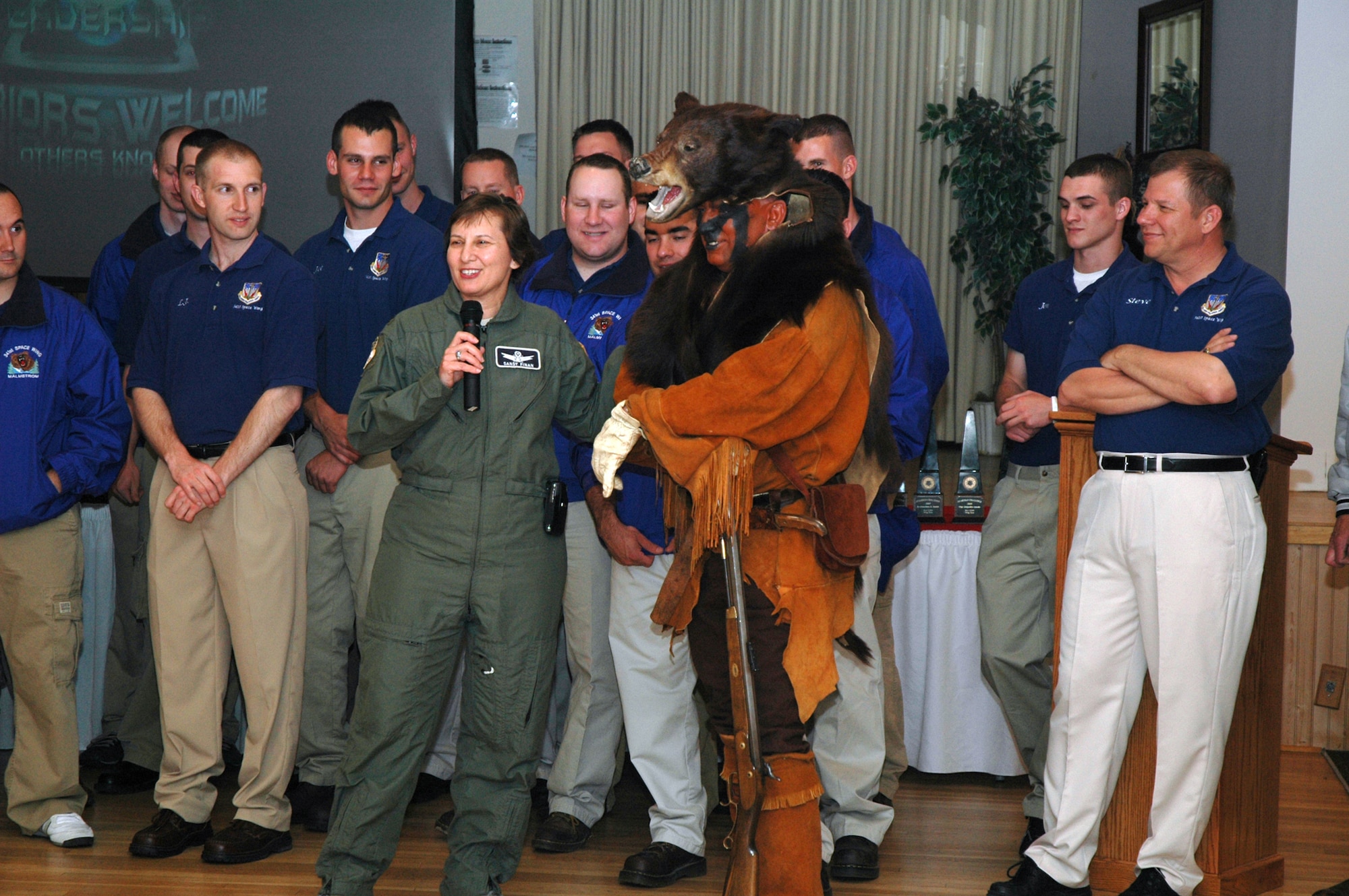 Col. Sandy Finan, 341st Space Wing commander, shares a story with the crowd about Grizz, Malmstrom's mascot, during the Guardian Challenge return ceremony at the Grizzly Bend Club here Monday. (U.S. Air Force photo/Airman 1st Class Emerald Ralston)