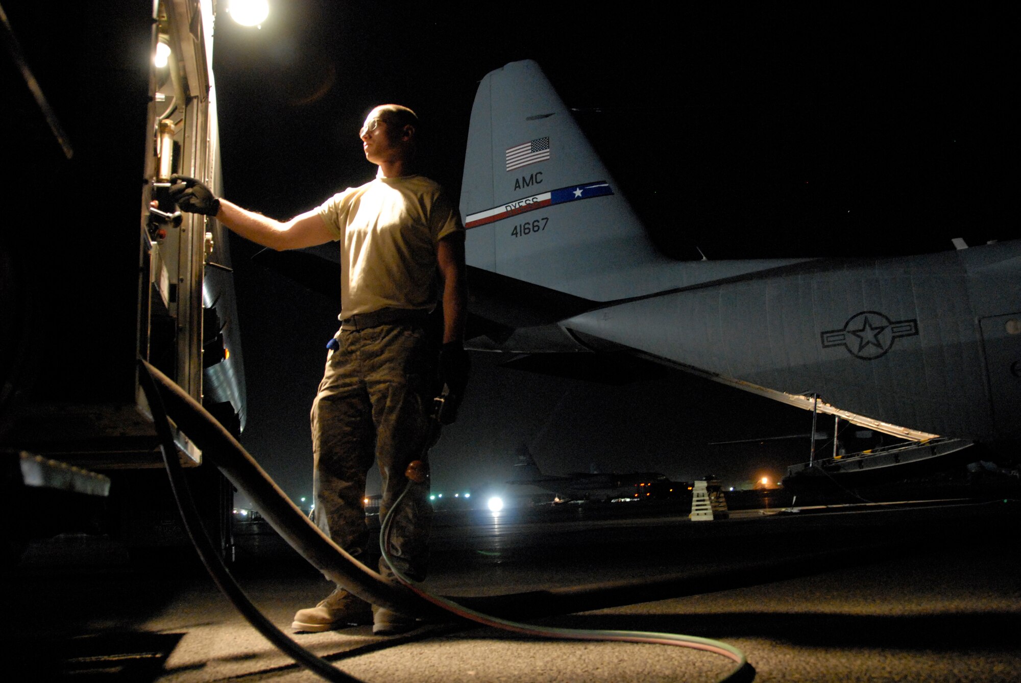SOUTHWEST ASIA -- Senior Airman Brian Gunther with the 386th Expeditionary Logistics Readiness Squadron’s fuels management flight tops off the tanks of an Air Force C-130 Hercules with nearly 2,500 gallons of JP8 fuel in May 2008. The refuel operation took place on an air base in the Persian Gulf Region prior to the aircraft departing for a mission to drop several hundred thousand leaflets over an Iraqi city. Airman Gunther is deployed from Royal Air Force Lakenheath, England. (U.S. Air Force photo/Tech. Sgt. Michael O’Connor)