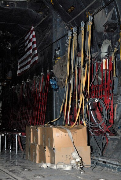 SOUTHWEST ASIA -- Several hundred thousand leaflets to be airdropped over an Iraqi city are strapped down with the static lines running from the leaflet boxes up to the anchor cable of an Air Force C-130 Hercules during an airdrop mission in May 2008. The anchor cable is also used by paratroopers when jumping from the aircraft in-flight and the static line is designed to rip open their parachute once they've cleared the aircraft and is pulled back in for reuse. (U.S. Air Force photo/Tech. Sgt. Michael O’Connor)