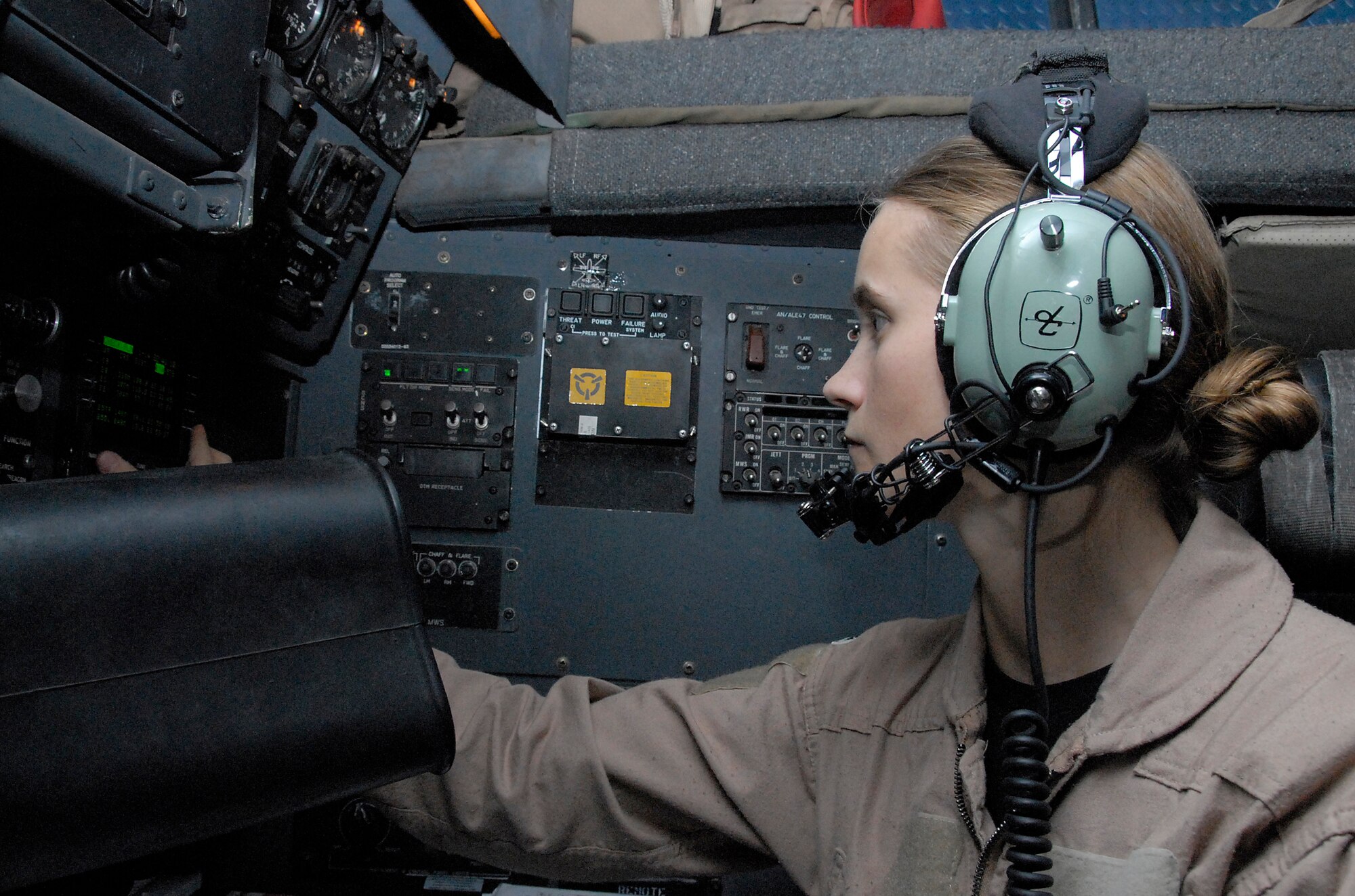 SOUTHWEST ASIA -- First Lt. Heather Hittler, an Air Force C-130 Hercules navigator deployed with the 737th Expeditionary Airlift Squadron, plugs in navigational information into a computer in preparation for departure from an air base in the Persian Gulf Region in May 2008. This mission dropped several hundred thousand leaflets over an Iraqi city. Lieutenant Hittler is deployed from Dyess Air Force Base, Texas. (U.S. Air Force photo/Tech. Sgt. Michael O’Connor)