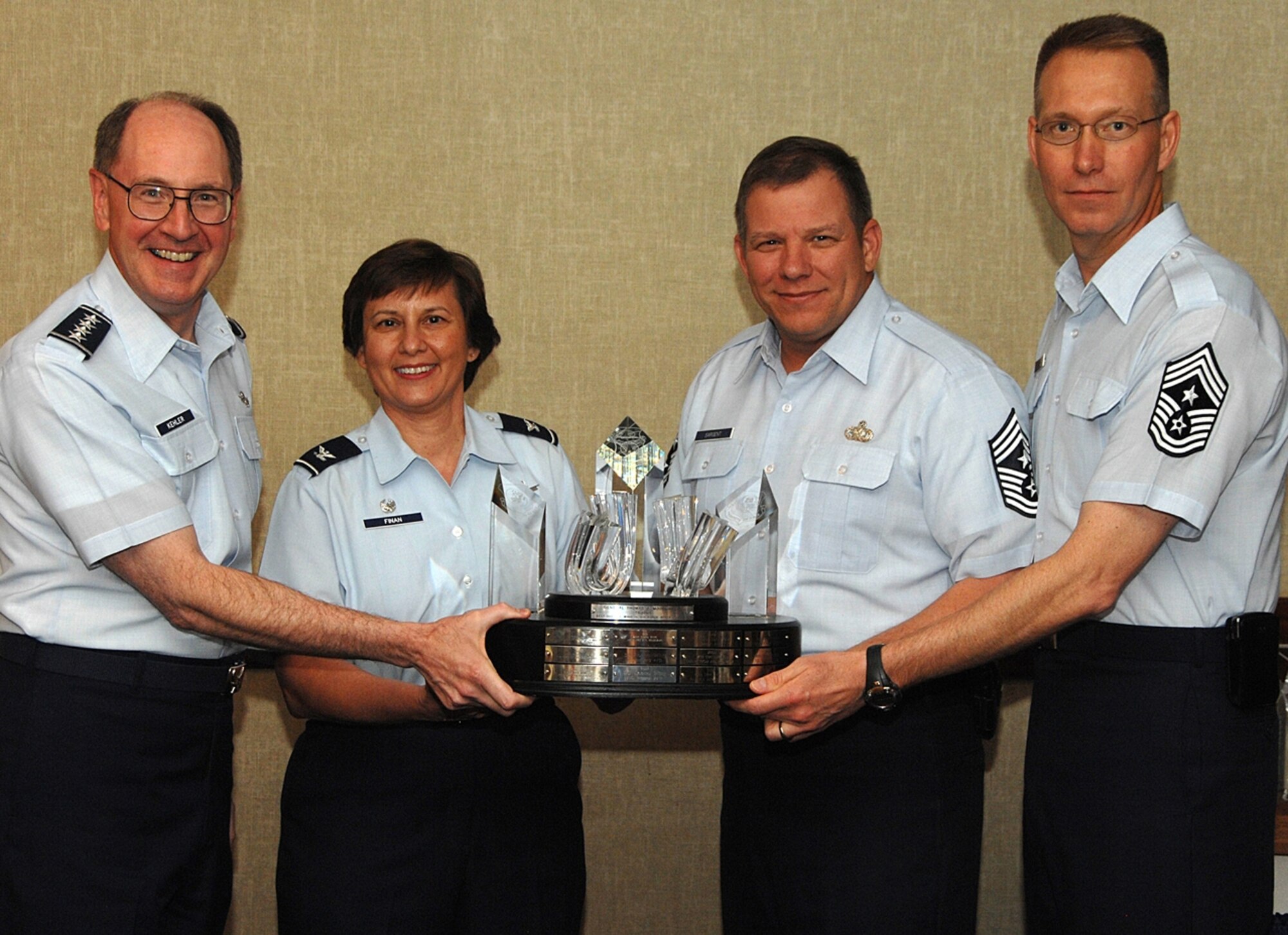 Air Force Space Command Commander Gen. C. Robert Kehler, 341st Space Wing Commander Col. Sandy Finan, 341st SW Command Chief Chief Master Sgt. Steve Sargent and AFSPC Command Chief Chief Master Sgt. Todd Small pose with the Moorman Trophy presented to Malmstrom May 6 during the Commanders Conference at Peterson Air Force Base, Colo. The Moorman Trophy is presented annually to the best wing in AFSPC. (U.S. Air Force photo)