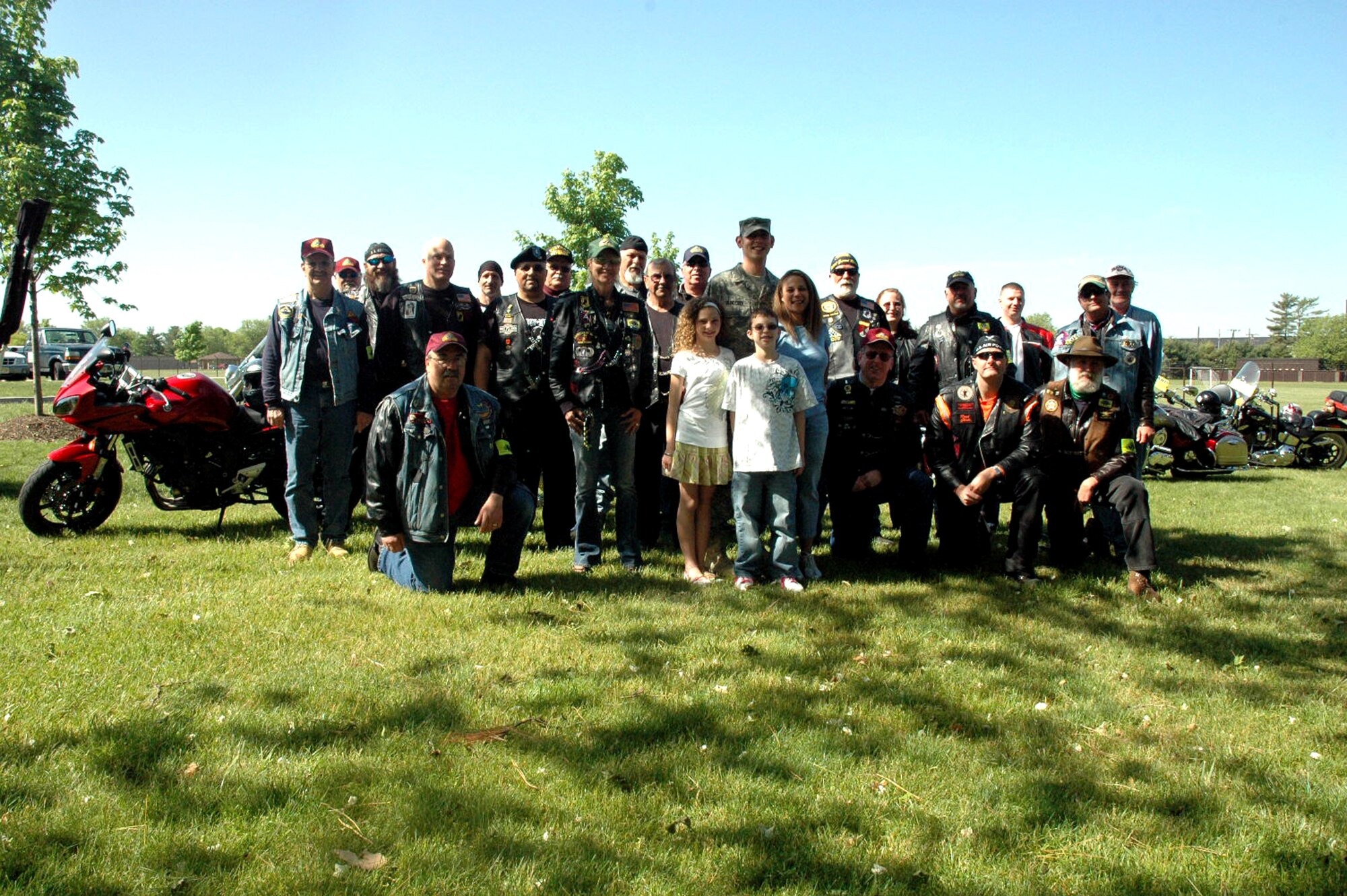 Staff Sgt. Peter Bundesen, center, stops for a group photo with members of the Patriot Guard Riders who escorted him home to McGuire Air Force Base, N.J., from the Philadelphia International Airport, May 14, 2008.  Sergeant Bundesen, from McGuire's 305th Aircraft Maintenance Squadron, was coming home from his deployment to Iraq.  The Patriot Guard Riders are "a diverse amalgamation of riders from across the nation who ride motorcycles and have an unwavering respect for those who risk their very lives for America?s freedom and security," according to their Web site.  (U.S. Air Force Photo/Tech. Sgt. Scott T. Sturkol)  