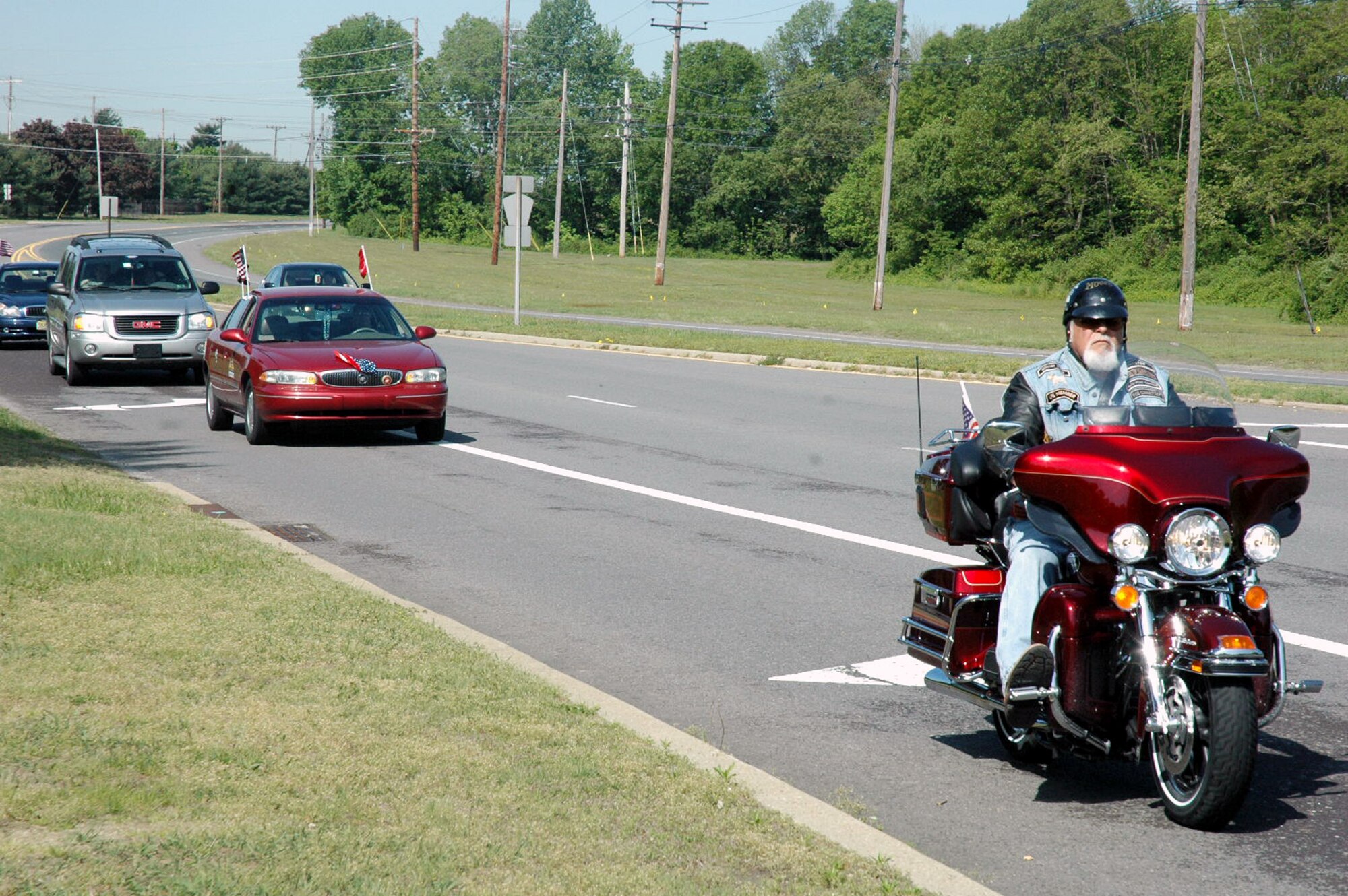 A group of motorcycle riders with the Patriot Guard Riders approach the main gate area of McGuire Air Force Base, N.J., May 14, 2008.  The contingent of Patriot Guard Riders escorted Staff Sgt. Peter Bundesen, from McGuire's 305th Aircraft Maintenance Squadron, from the Philadelphia International Airport to McGuire after Sergeant Bundesen returned from a deployment to Iraq. The Patriot Guard Riders are "a diverse amalgamation of riders from across the nation who ride motorcycles and have an unwavering respect for those who risk their very lives for America?s freedom and security," according to their Web site.  (U.S. Air Force Photo/Tech. Sgt. Scott T. Sturkol)  