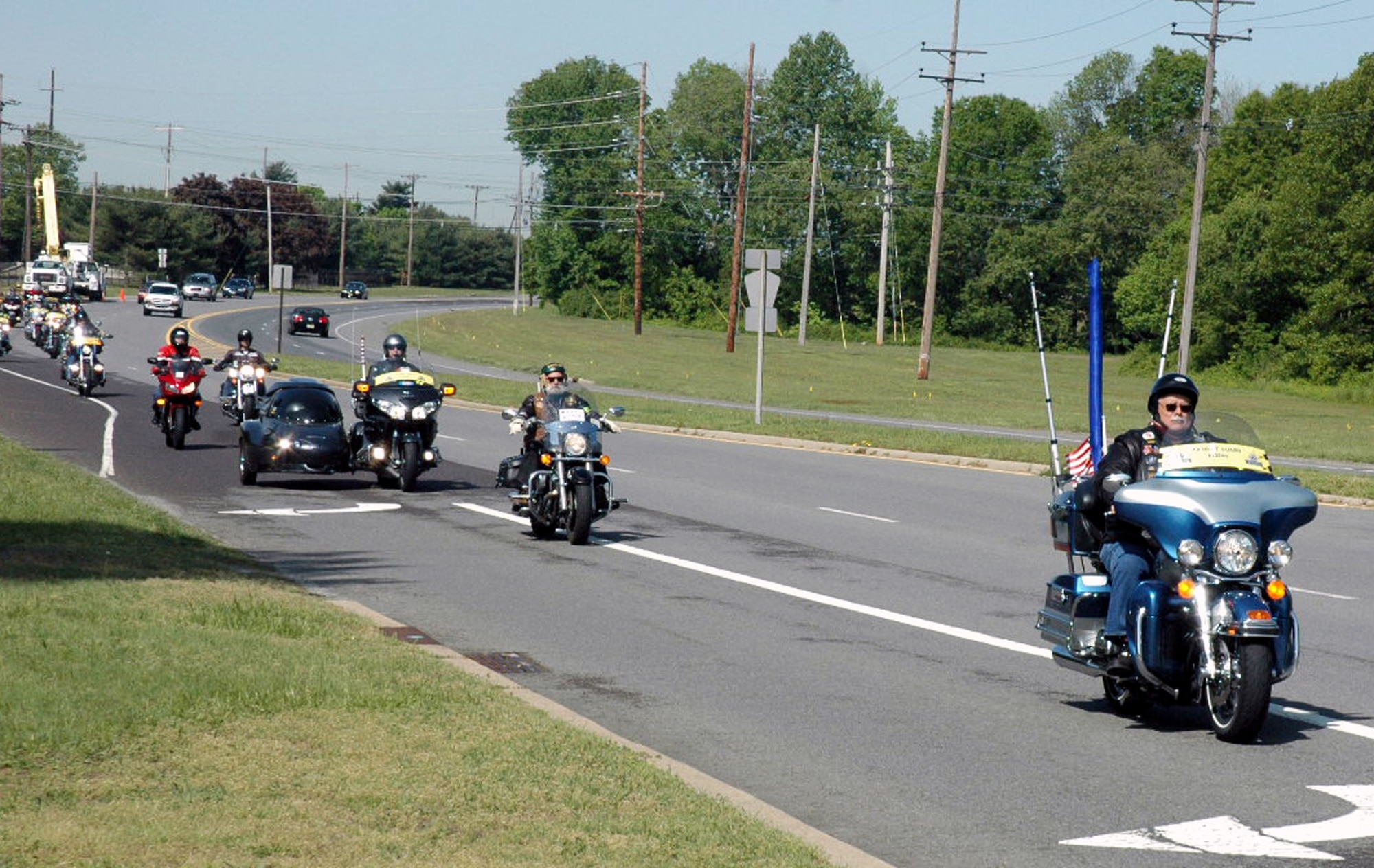 A group of motorcycle riders with the Patriot Guard Riders approach the main gate area of McGuire Air Force Base, N.J., May 14, 2008.  The contingent of Patriot Guard Riders escorted Staff Sgt. Peter Bundesen, from McGuire's 305th Aircraft Maintenance Squadron, from the Philadelphia International Airport to McGuire after Sergeant Bundesen returned from a deployment to Iraq. The Patriot Guard Riders are "a diverse amalgamation of riders from across the nation who ride motorcycles and have an unwavering respect for those who risk their very lives for America?s freedom and security," according to their Web site.  (U.S. Air Force Photo/Tech. Sgt. Scott T. Sturkol)  