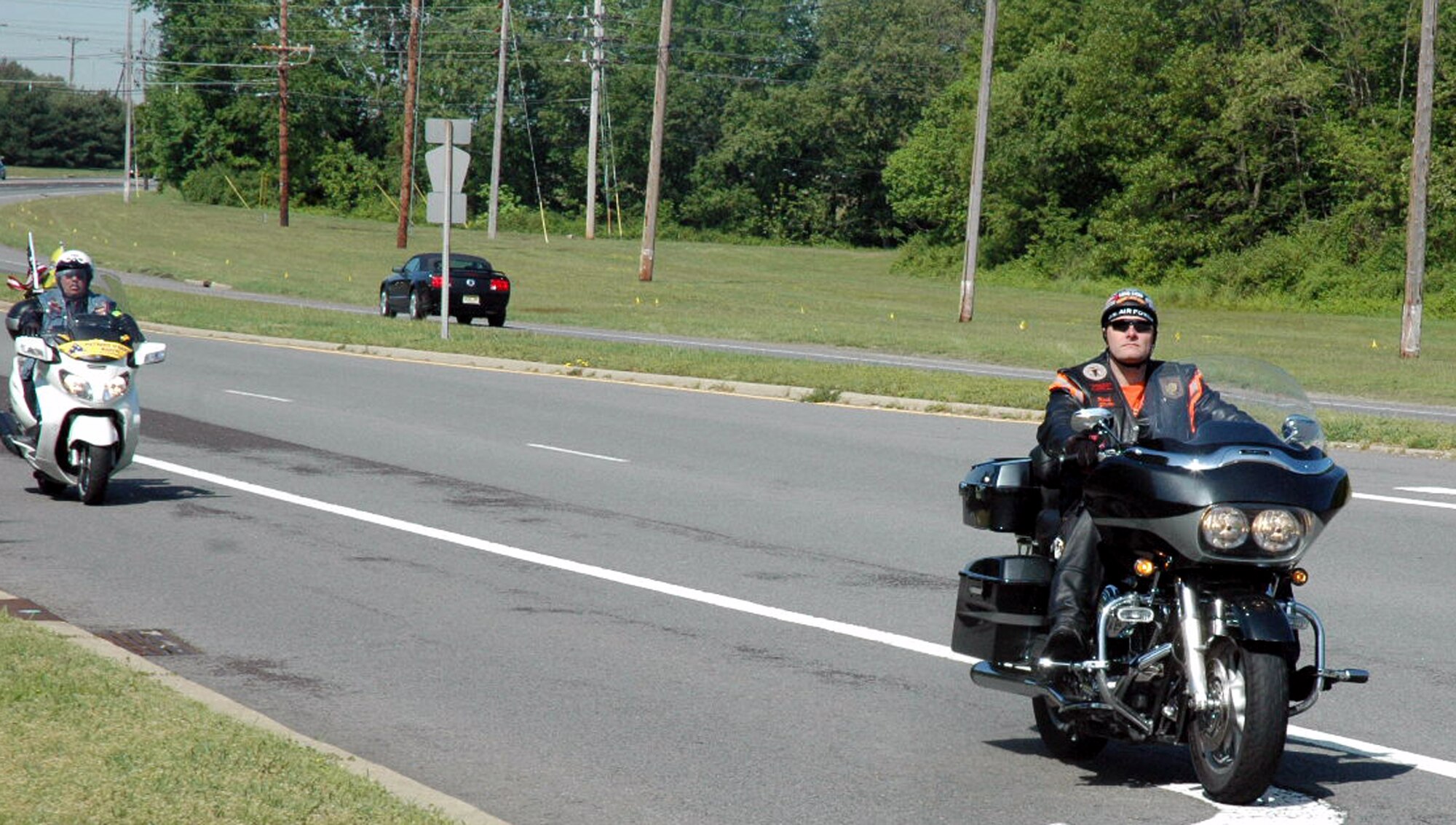 Tech. Sgt. Ryan Holmes, from the U.S. Air Force Expeditionary Center on Fort Dix, N.J., leads a group of motorcycle riders with the Patriot Guard Riders as they approach the main gate area of McGuire Air Force Base, N.J., May 14, 2008.  The contingent of Patriot Guard Riders escorted Staff Sgt. Peter Bundesen, from McGuire's 305th Aircraft Maintenance Squadron, from the Philadelphia International Airport to McGuire after Sergeant Bundesen returned from a deployment to Iraq. The Patriot Guard Riders are "a diverse amalgamation of riders from across the nation who ride motorcycles and have an unwavering respect for those who risk their very lives for America?s freedom and security," according to their Web site.  (U.S. Air Force Photo/Tech. Sgt. Scott T. Sturkol)  