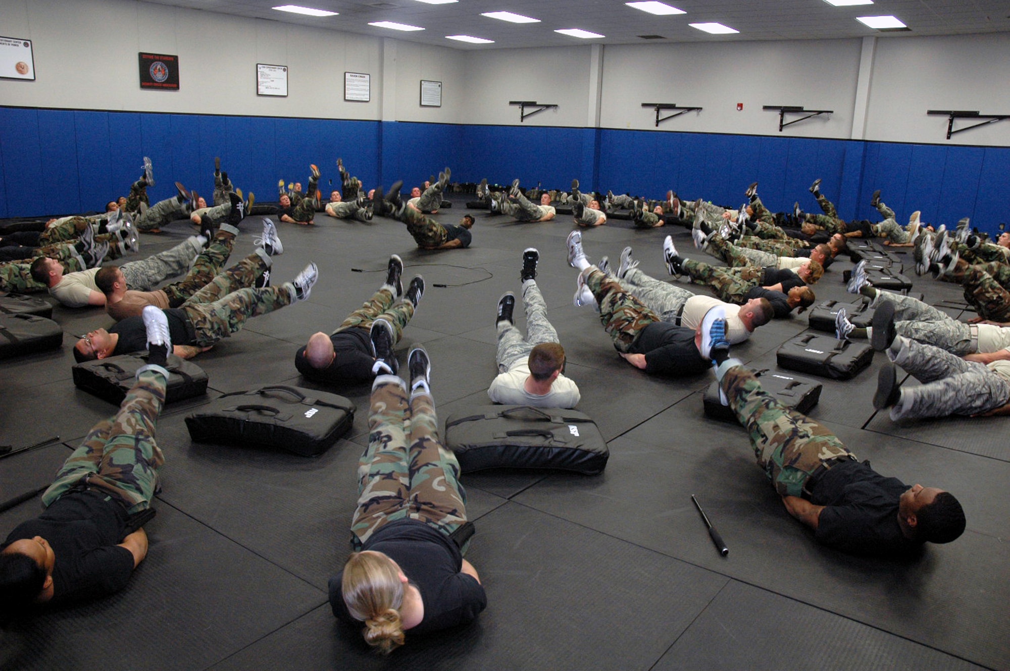 Instructor Staff Sgt. Rudolph Stuart (center) leads students in the Air Force Fly-Away Security Team training course in completing exercise as part of training for the course in the U.S. Air Force Expeditionary Center May 12, 2008, on Fort Dix, N.J.  The course, taught by the Center's 421st Combat Training Squadron, prepares security forces Airmen for fly-away security missions once they are deployed to the U.S. Central Command area of responsibility.  (U.S. Air Force Photo/Tech. Sgt. Scott T. Sturkol)
