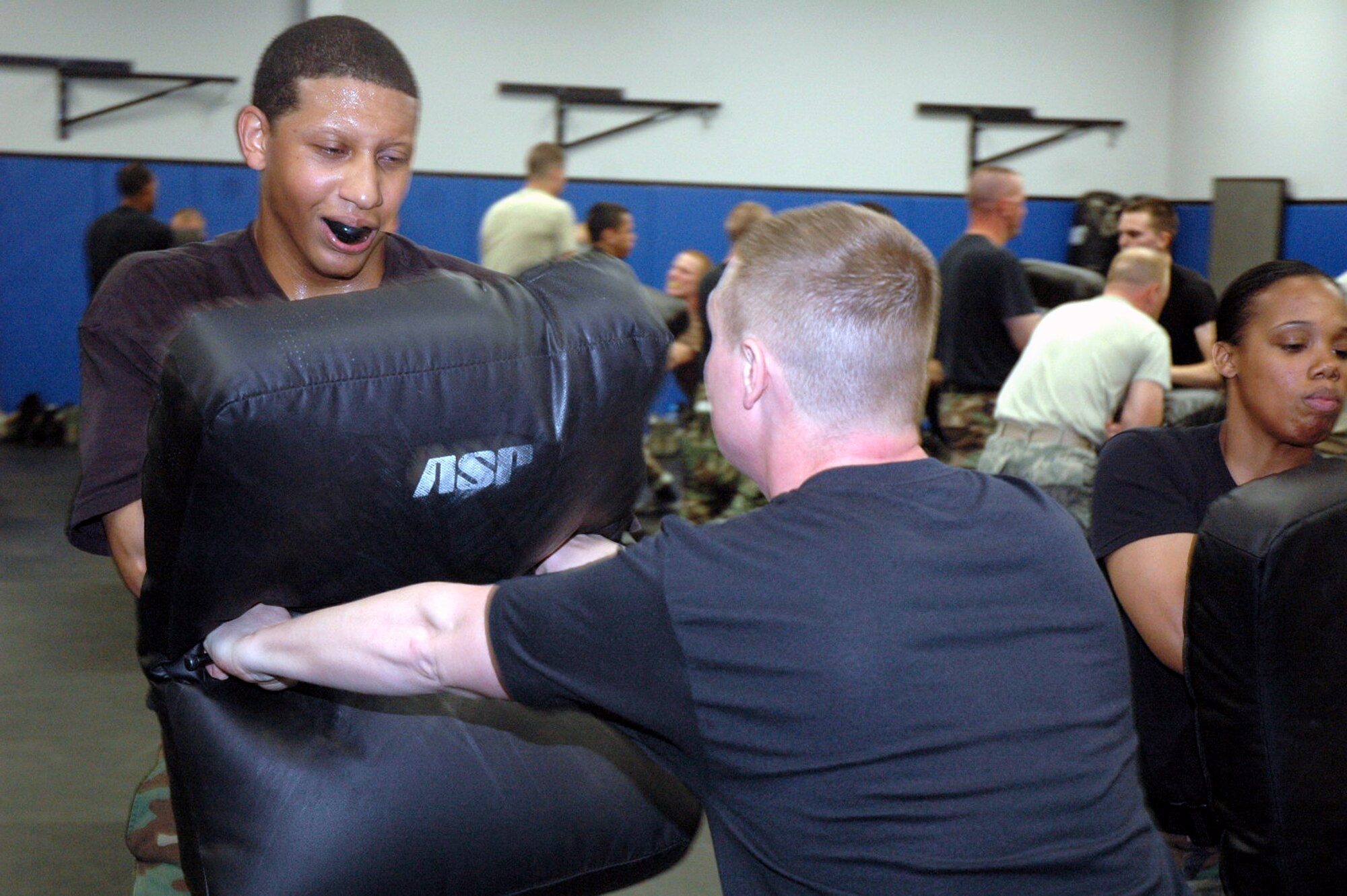 Students in the Air Force Fly-Away Security Team training course practice combatives with the ASP baton during training in the U.S. Air Force Expeditionary Center May 12, 2008, on Fort Dix, N.J.  The course, taught by the Center's 421st Combat Training Squadron, prepares security forces Airmen for fly-away security missions once they are deployed to the U.S. Central Command area of responsibility.  (U.S. Air Force Photo/Tech. Sgt. Scott T. Sturkol)