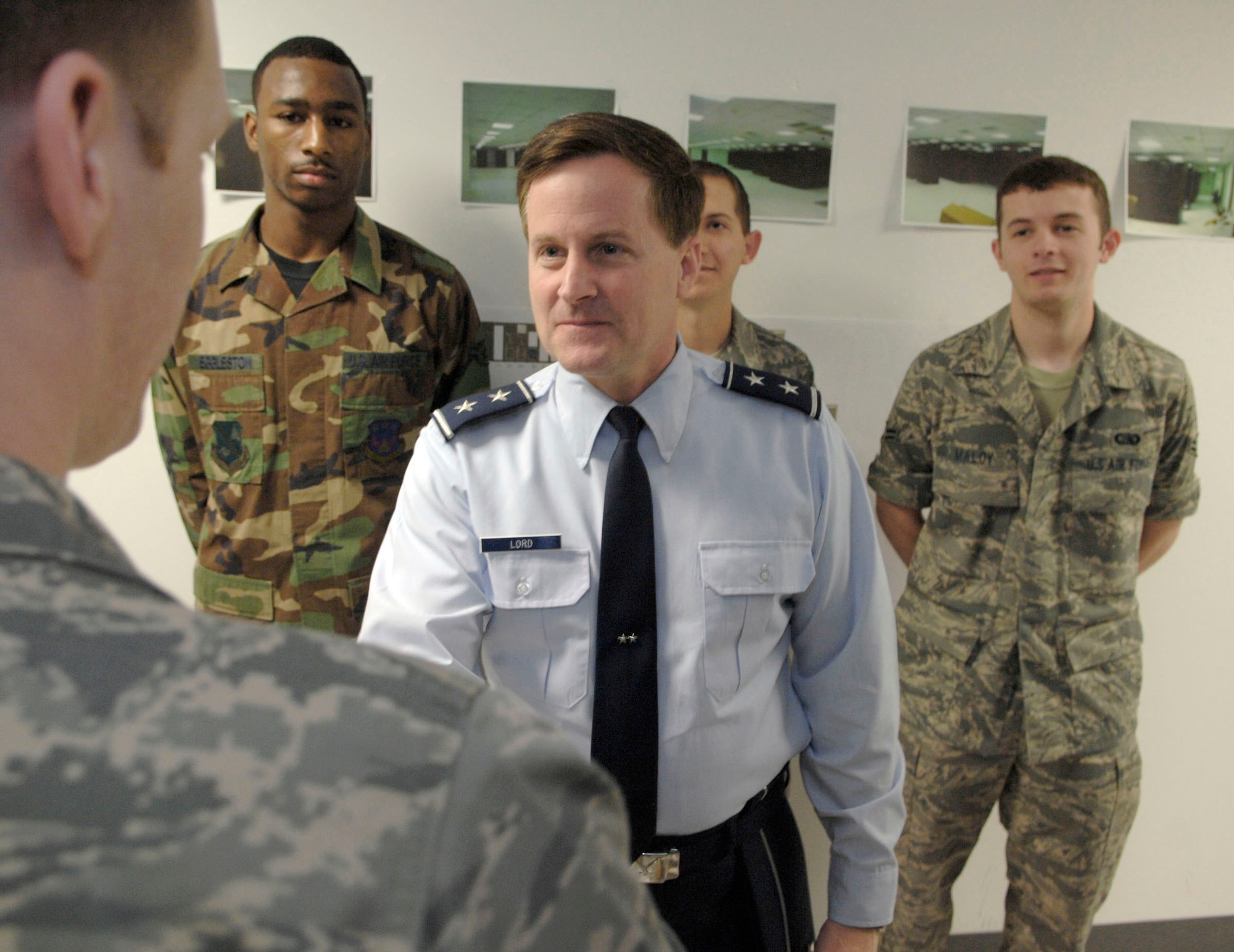 Maj. Gen. William T. Lord greets Staff Sgt. Christopher Newbill, Senior Airman Sean Manning, and Airmen 1st Class Taji Eggleston and Brenden Maloy May 1at Andrews Air Force Base, Md. The Airmen helped install the Air Force's newest Area Processing Center there. The APC consolidates e-mail, file sharing and many other data and information services for more than 160,000 Air Force workers. General Lord is the Air Force Cyber Command provisional commander. (U.S. Air Force photo/Senior Airman Steven Doty)
