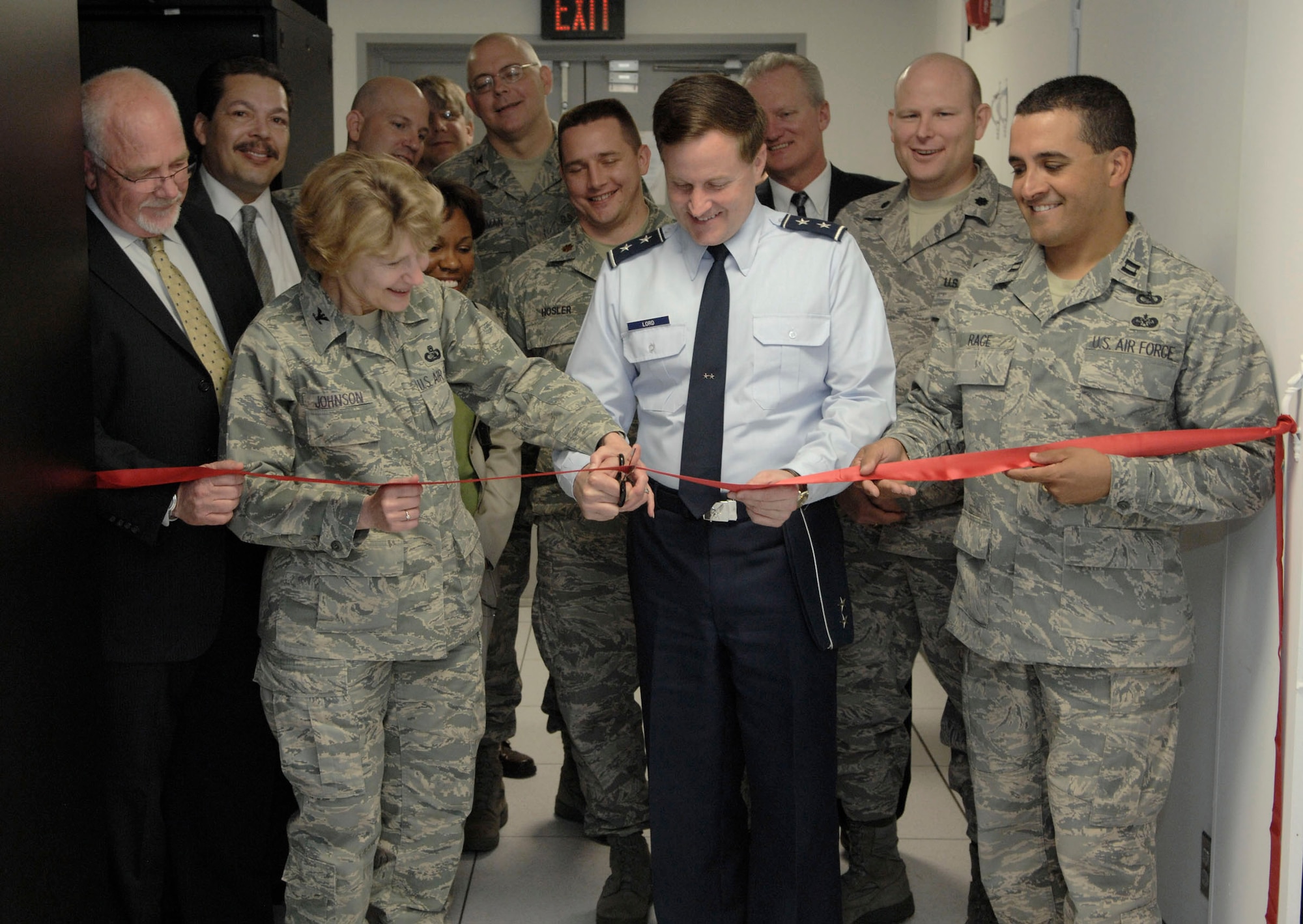 Maj. Gen. William T. Lord and Col. Kim Johnson cut the ribbon May 1 on the Andrews Area Processing Center at Andrews Air Force Base, Md. The APC consolidates e-mail, file sharing and many other data and information services for more than 160,000 Air Force workers. General Lord is the Air Force Cyber Command provisional commander and Colonel Johnson is the 844th Communications Group commander. (U.S. Air Force photo/Senior Airman Steven Doty) 