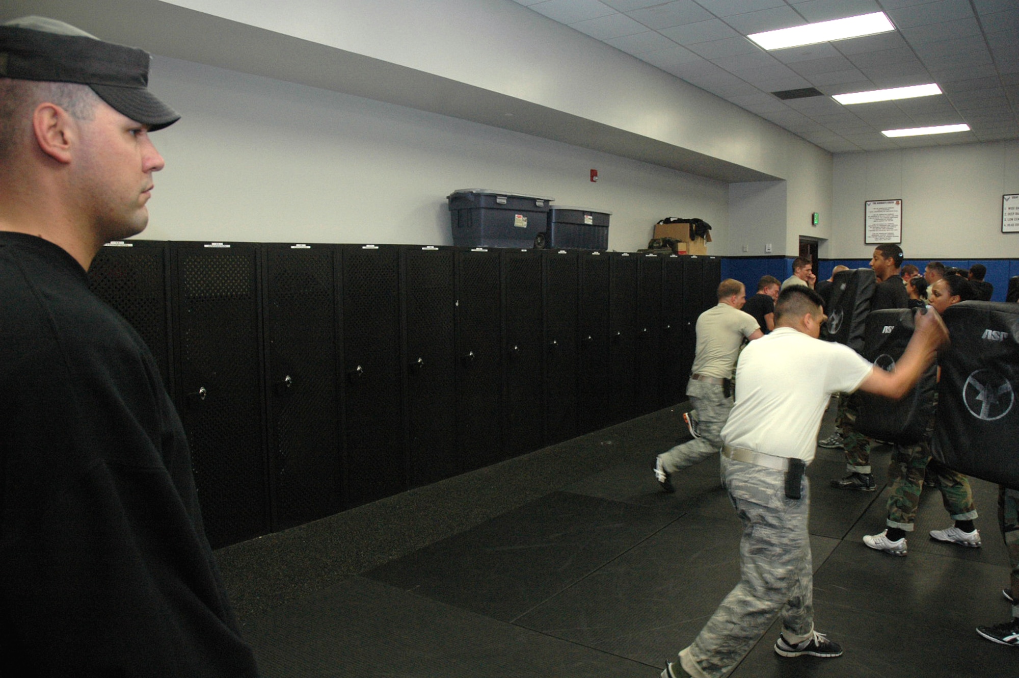 Tech. Sgt. Daniel Koenigsmann, instructor for the U.S. Air Force Expeditionary Center's 421st Combat Training Squadron, oversees combatives training for students in the Air Force Fly-Away Security Team training course May 12, 2008, inside the Center on Fort Dix, N.J.  The course prepares security forces Airmen for fly-away security missions once they are deployed to the U.S. Central Command area of responsibility.  (U.S. Air Force Photo/Tech. Sgt. Scott T. Sturkol)
