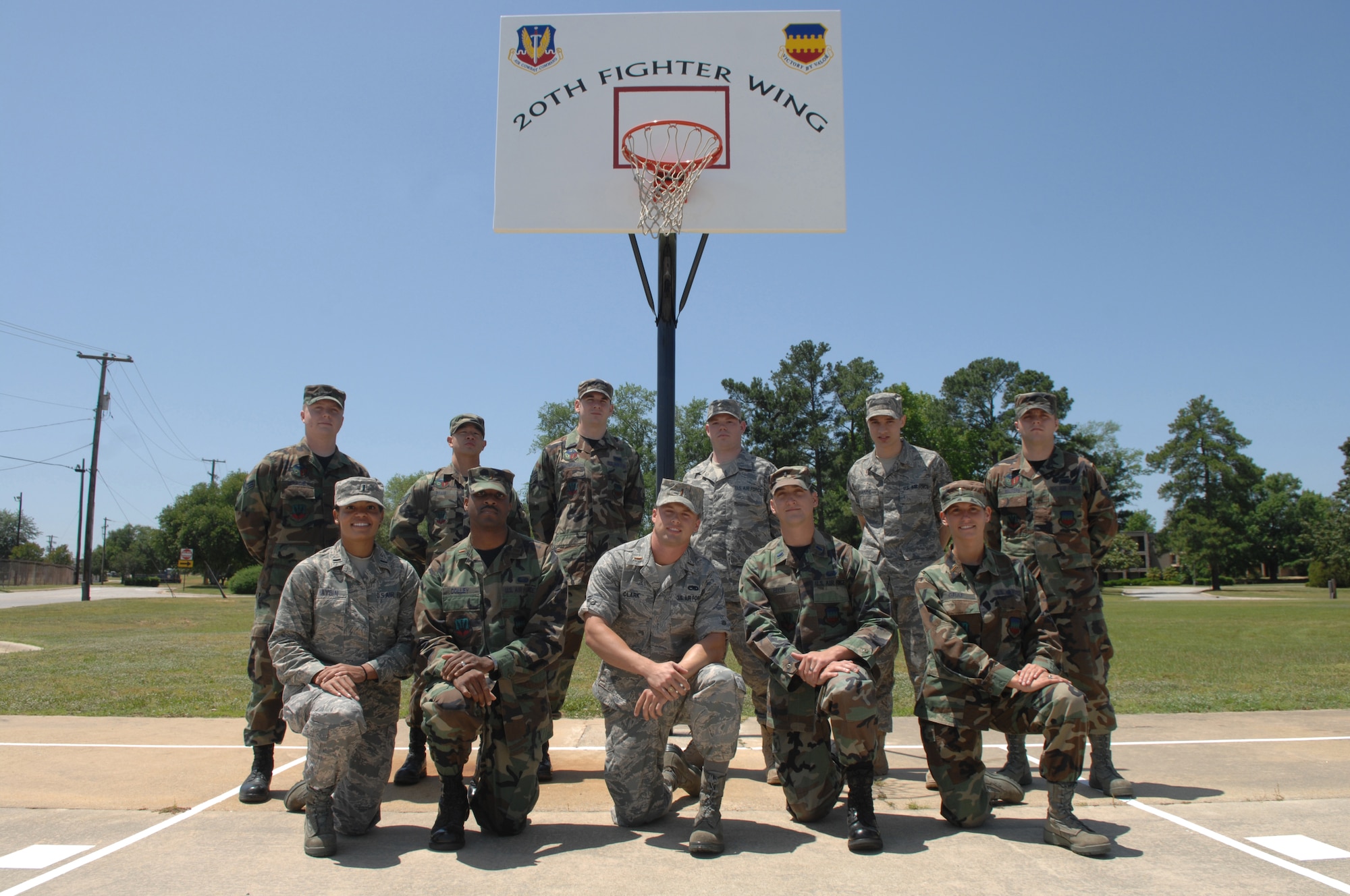 SHAW AIR FORCE BASE, S.C. -- Memebrs of The 20th Fighter Wing Company Grade Officers Council and the 20th Equipment Maintenance Squadron Fabrication Flight pose for a group photo May 13, 2008. The two groups teamed up for the "find it fix it program" and refurbished the basketball court near the base track. They painted new lines on the court, sanded and painted the poles and backboard and replaced the rims. The project was completed May 9, 2008. (U.S. Air Force photo/Staff Sgt. Nathan Bevier)