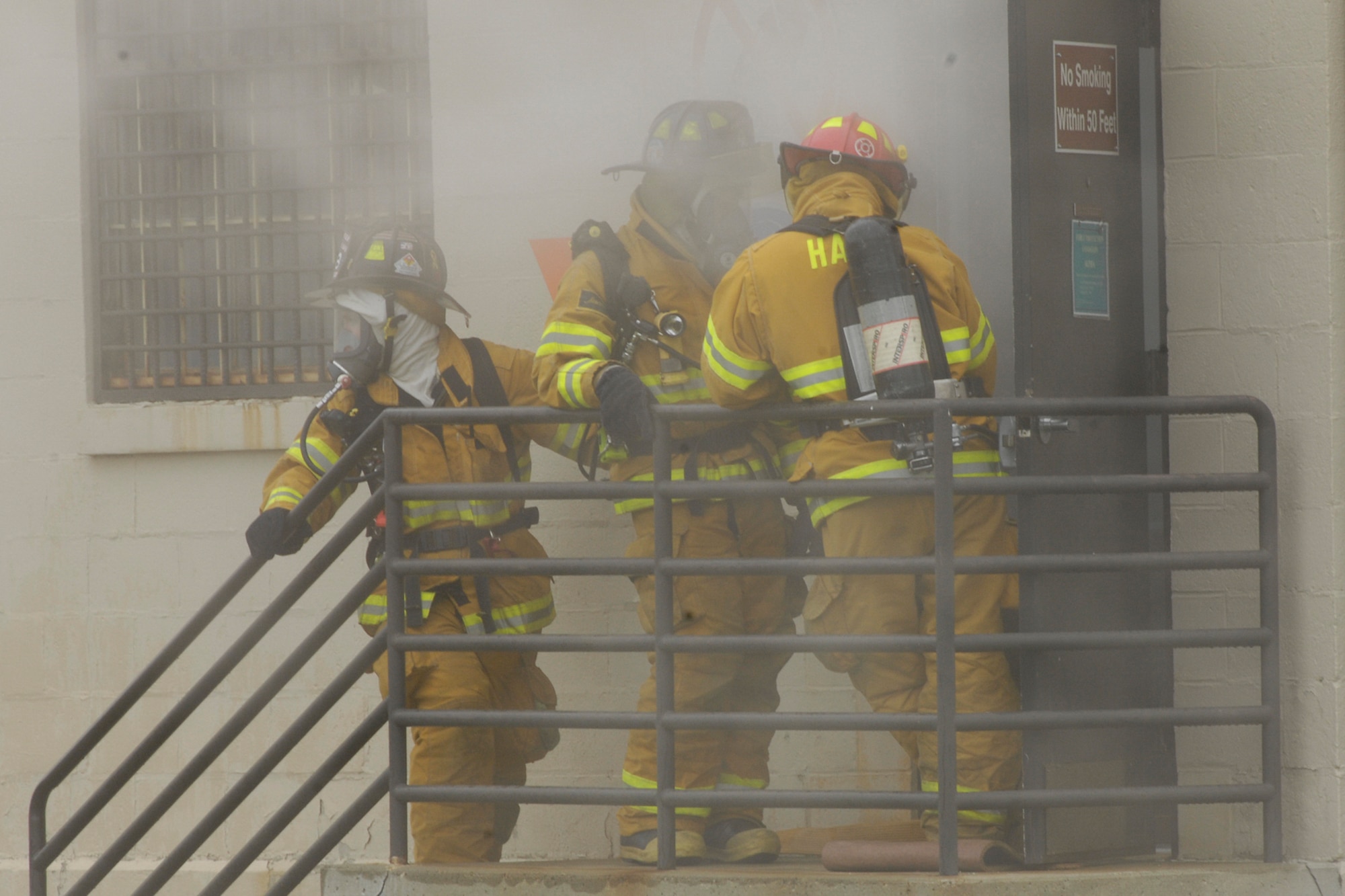 HANSCOM AFB, Mass. – Members of the Hanscom Fire Department respond to a simulated munitions fire in Building 1208 on May 12 as part of a Base Readiness Exercise that took place May 12 to 16. The exercise was designed to evaluate Hanscom’s readiness including deployments, emergency management and wartime materiel support.  (U.S. Air Force photo by Linda LaBonte Britt)