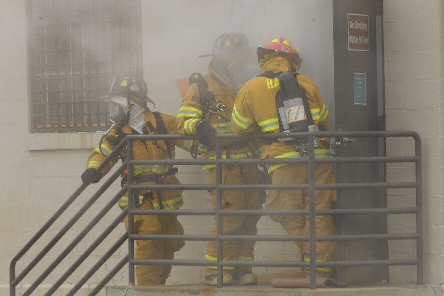 HANSCOM AFB, Mass. – Members of the Hanscom Fire Department respond to a simulated munitions fire in Building 1208 on May 12 as part of a Base Readiness Exercise that took place May 12 to 16. The exercise was designed to evaluate Hanscom’s readiness including deployments, emergency management and wartime materiel support.  (U.S. Air Force photo by Linda LaBonte Britt)