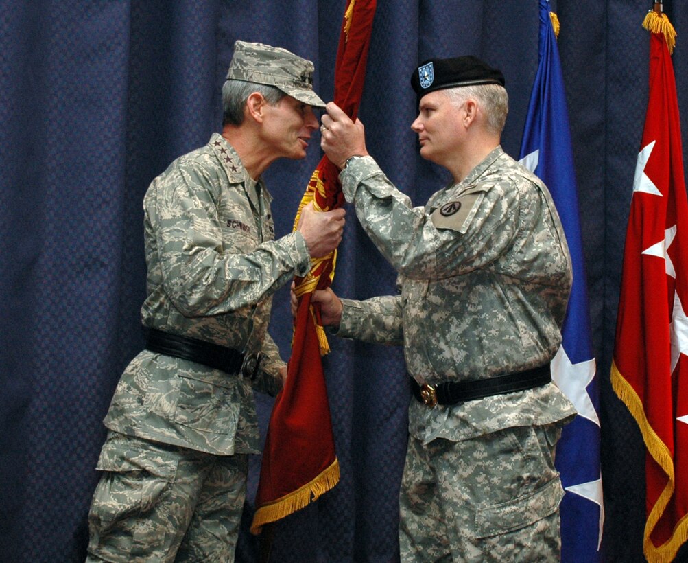 SCOTT AIR FORCE BASE, Ill. -- Gen. Norton. A. Schwartz, U.S. Transportation Command commander, passes the Transportation Corps flag to Brig. Gen. Brian Layer, incoming acting Military Surface Deployment and Distribution Command commander, during the SDDC change of command ceremony May 12 at USTRANSCOM. (U.S. Air Force photo/ Bob Fehringer)