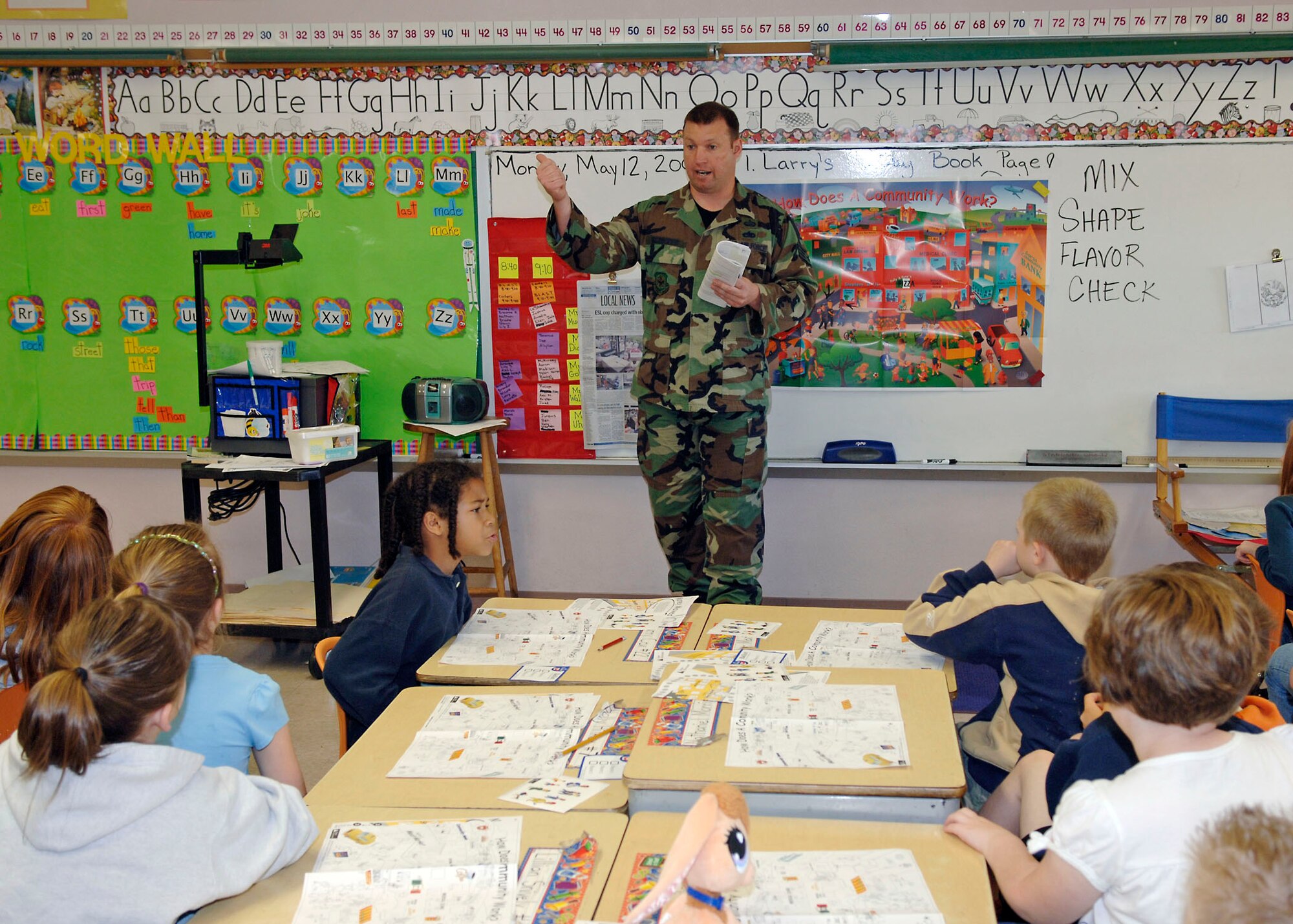 SCOTT AIR FORCE BASE, Ill. -- Staff Sgt. Fred Schmitt, Air Mobility Command Installations and Mission Support, teaches second graders about community issues during Junior Achievement in a Day held at Douglas Elementary School in Belleville, Ill. “JA in a Day” is a special Junior Achievement delivery method that facilitates a partnership between Scott AFB members and Douglas Elementary. (U.S. Air Force photo/Tech. Sgt. Tony Tolley)