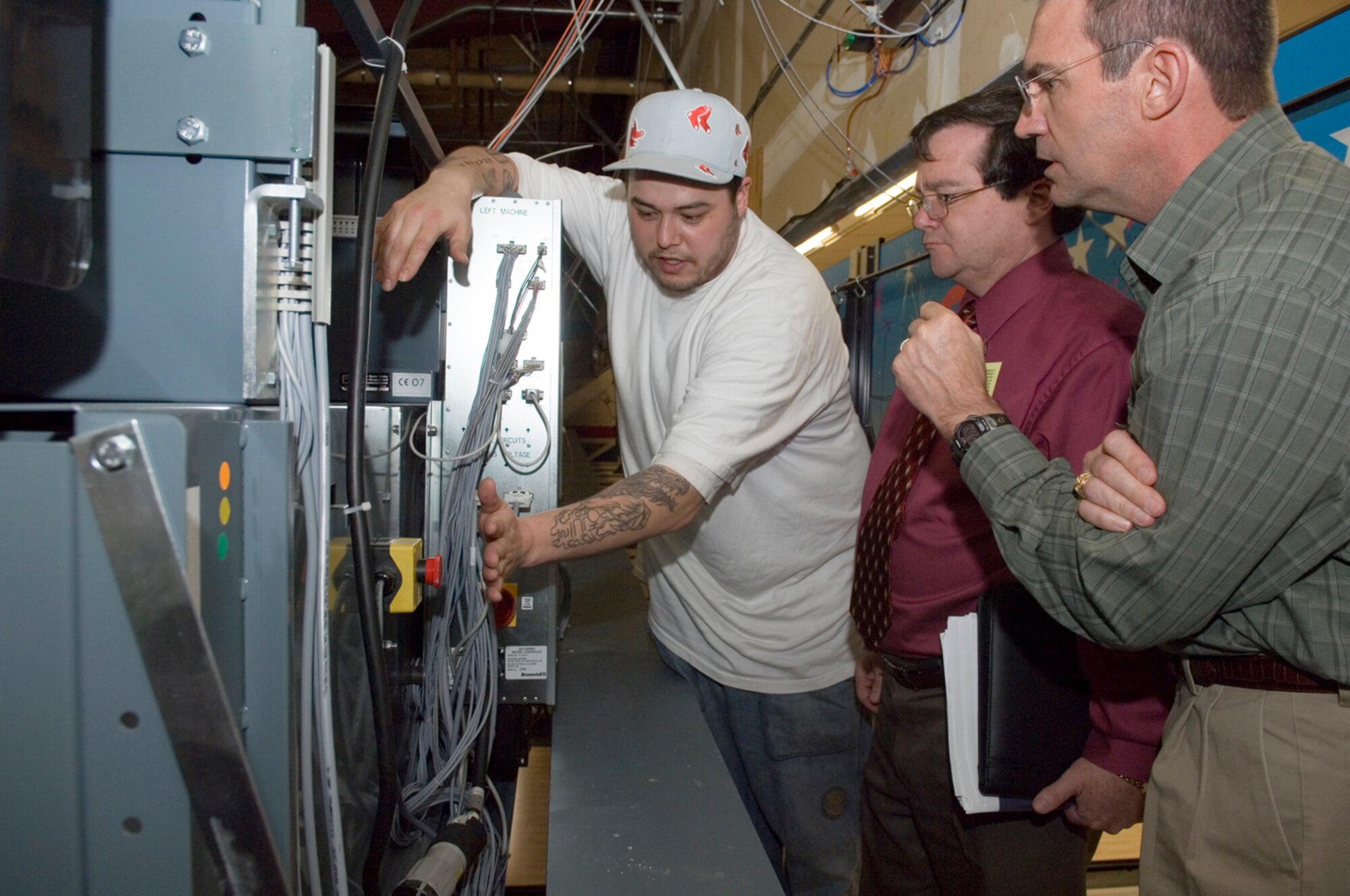 HANSCOM AFB, Mass. – From left, Andy Croxford, Hanscom Bowling Center, maintenance technician, reviews safety procedures on May 7 during the ESOCAMP inspection with evaluator Vincent Dotson, Air Force Materiel Command Safety Office and observer Michael Lovell, Air Force Research Laboratory, Detachment 4, Rome, N.Y.   (U.S. Air Force photo by Rick Berry)