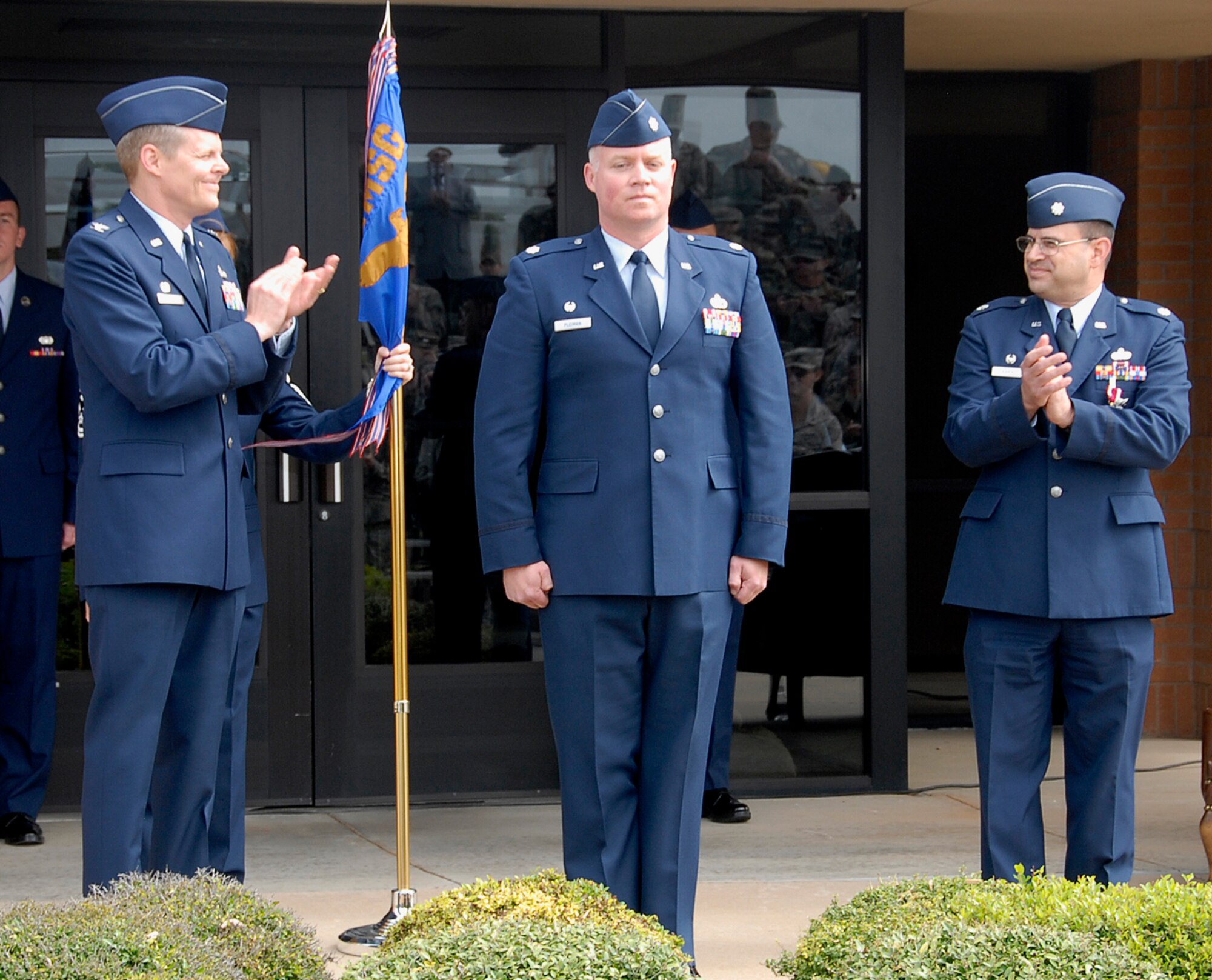 Col. Richard Lipsey, the commander of the 82nd Mission Support Group, and Lt. Col. Gus Kirkikis, the outgoing commander of the 82nd Civil Engineering Squadron welcome Lt. Col. Christopher Pleiman, the incoming commander of the 82nd CES, at the 82nd CES change-of-command ceremony May 12. (U.S. Air Force photo/Mike Litteken)