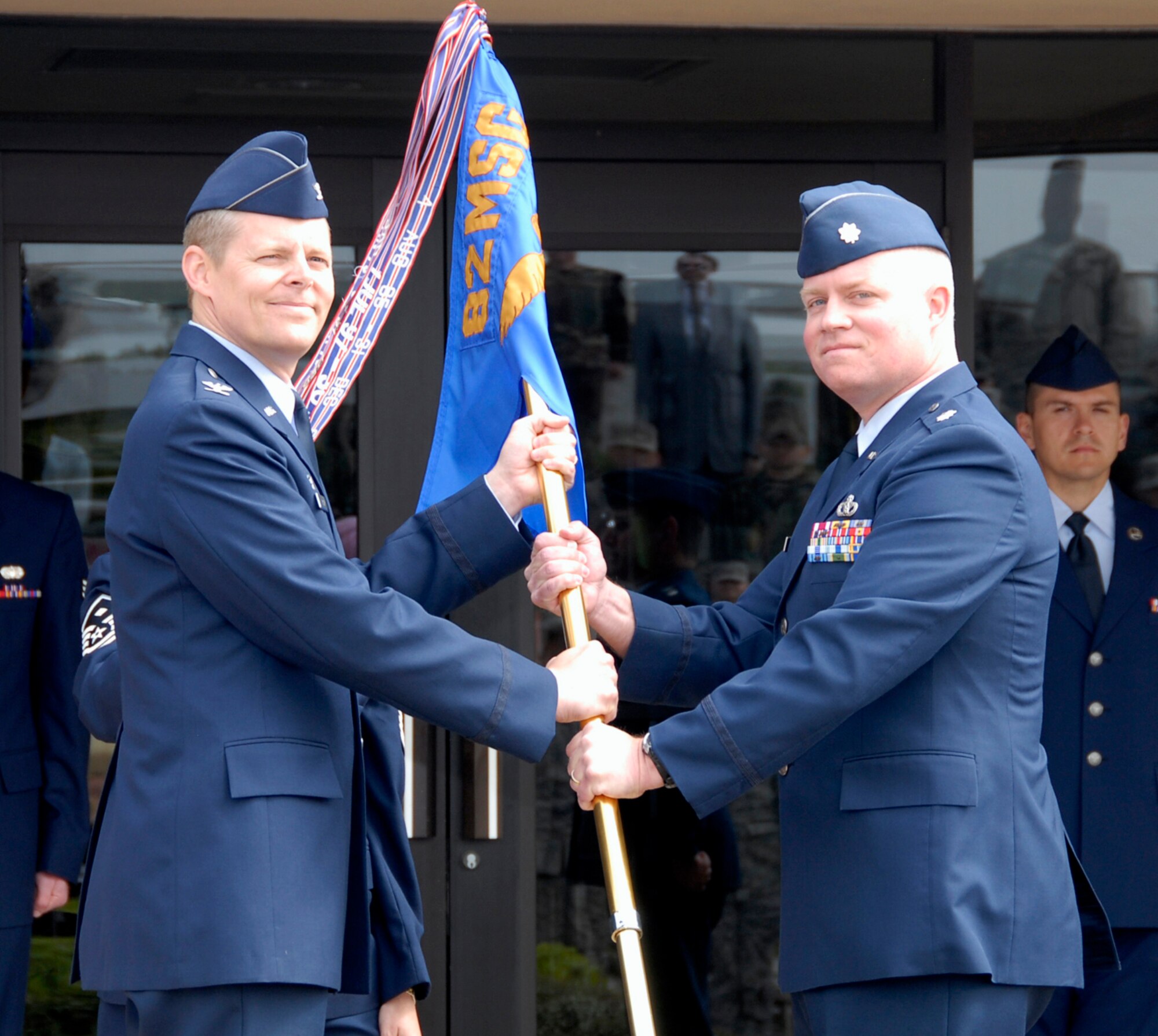 Col. Richard Lipsey, the commander of the 82nd Mission Support Group, hands the guidon to Lt. Col. Christopher Pleiman, the incoming commander of the 82nd Civil Engineering Squadron, at the 82nd CES change-of-command ceremony May 12. (U.S. Air Force photo/Mike Litteken)