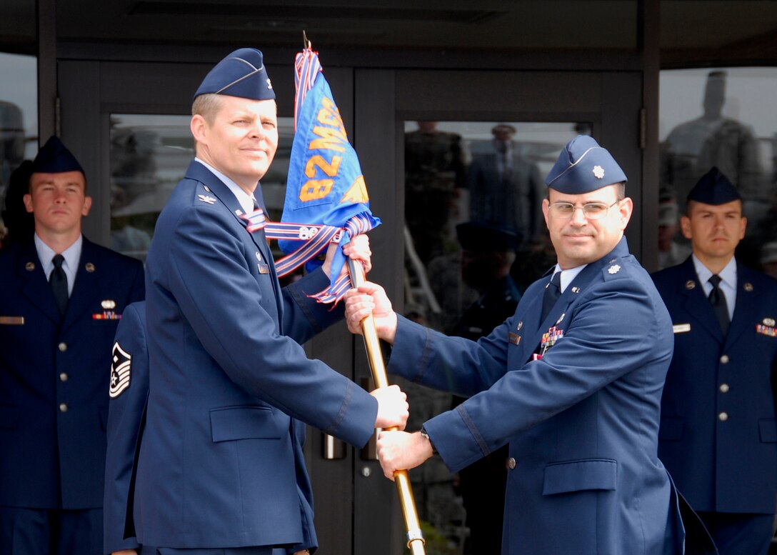 Lt. Col. Gus Kirkikis, the outgoing commander of the 82nd Civil Engineering Squadron, hands the guidon to Col. Richard Lipsey, the commander of the 82nd Mission Support Group,  at the 82nd CES change-of-command ceremony May 12. (U.S. Air Force photo/Mike Litteken)