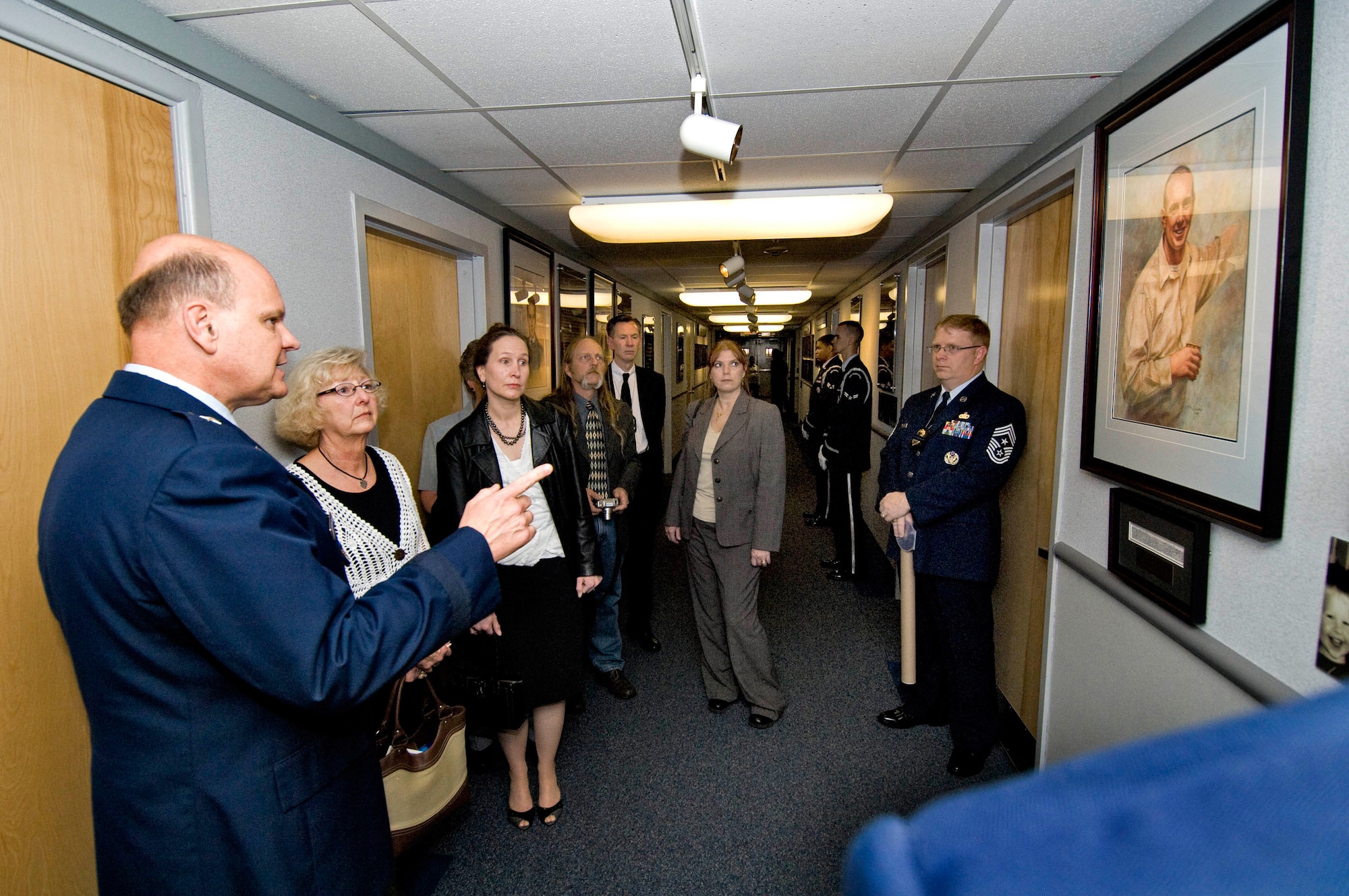 Brigadier General Dana Simmons, commander, Air Force Office of Special Investigations, tours the AFOSI Hall of Heroes with family members of Special Agent Thomas Crowell. (U.S. Air Force photo/Mike Hastings)