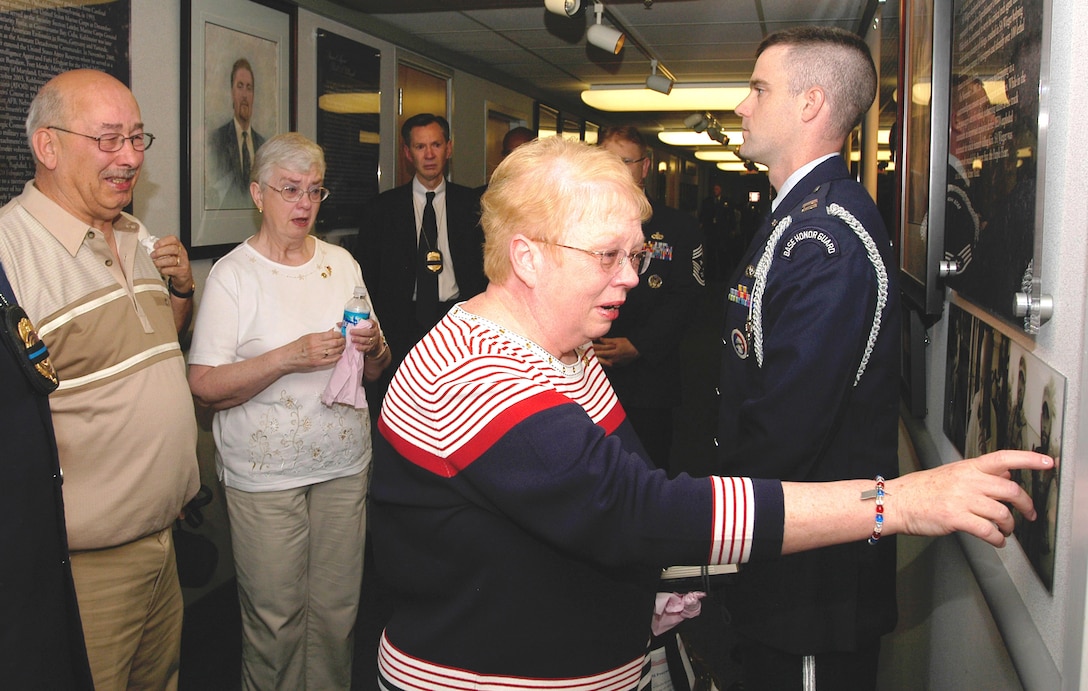 Lorraine Wieger, mother of Special Agent David Wieger, cries as she touches a picture of her son who was killed in Iraq on November 1, 2007. A portrait of SA Wieger and four other special agents were dedicated May 13 in the Headquarters Building, Air Force Office of Special Investigations Hall of Heroes. Agent Wieger was killed when his vehicle was struck by an improvised explosive device. Special Agent Wieger was posthumously awarded the Bronze Star, Purple Heart, Air Force Commendation Medal and the Air Force Combat Action Medal. (U.S. Air Force photo/Tech. Sgt. John Jung)