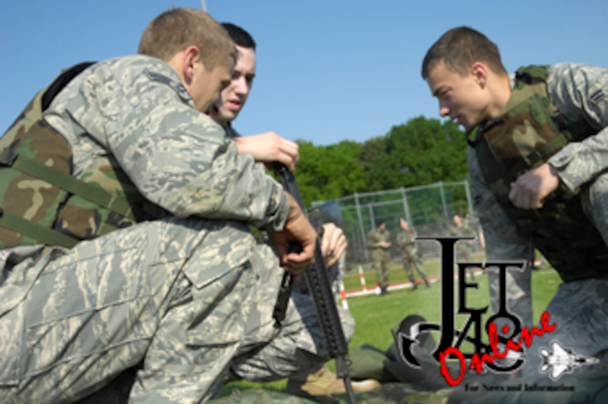 Staff Sergeant John Smith, Senior Airman  Grant Betts and A1C Meldion Shehu gather the parts to assemble an M-16. May. 13 at RAF Lakenheath. Assembling an M-16 was one of the tasks required for the combat challenge, during police week. (U.S. Air Force photo by Airman Perry Aston)