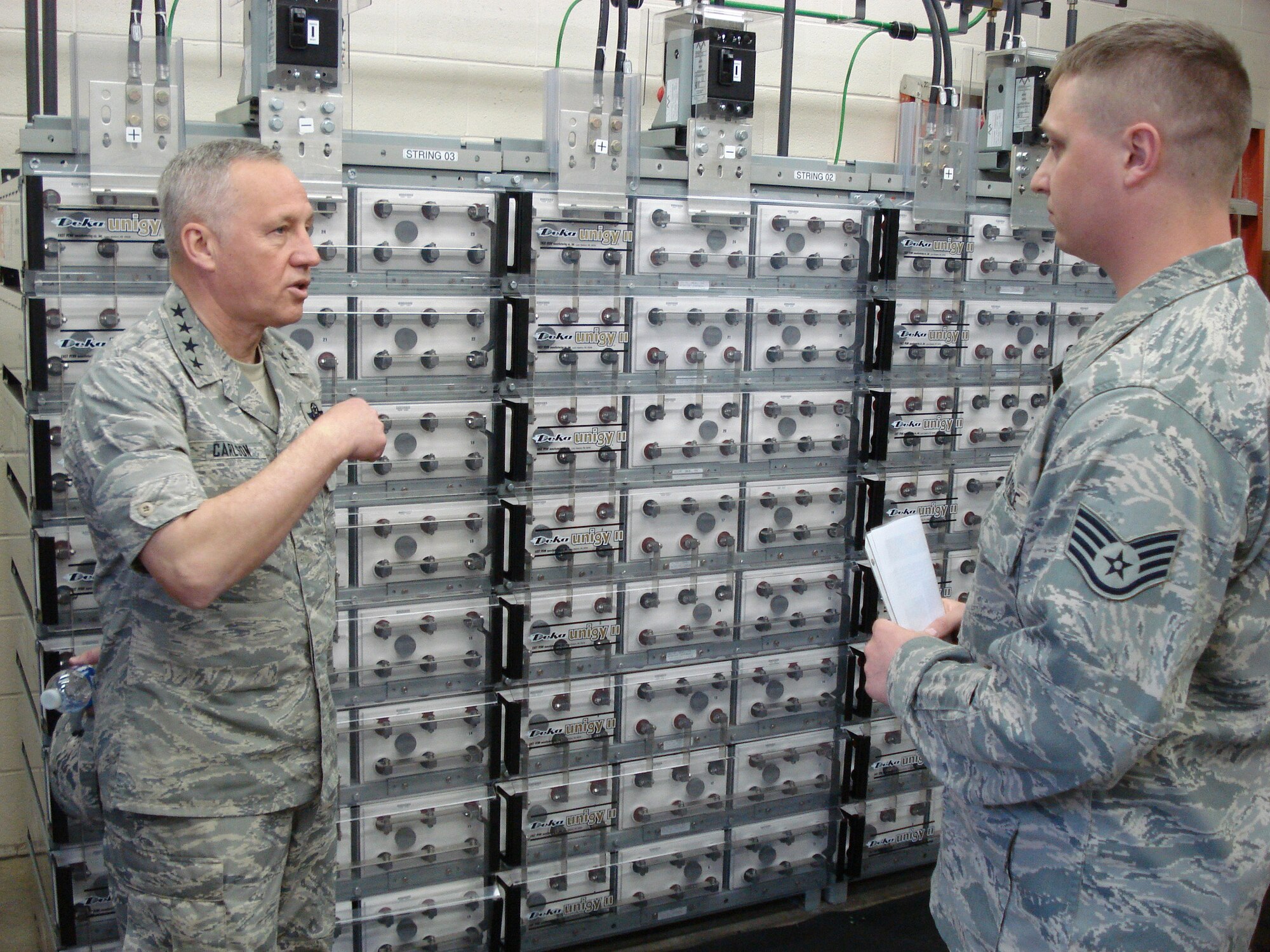 Gen. Bruce Carlson, Air Force Materiel Command commander, discusses the Power Distribution System Replacement Project for the Wright-Patterson Air Force Base telephone switching network with Staff Sgt. Thomas Troup, 88th Communications Squadron.  Gen. Carlson toured 88th Air Base Wing facilities and met with base Airmen and employees May 8. (U.S. Air Force photo/Derek Kaufman)  
