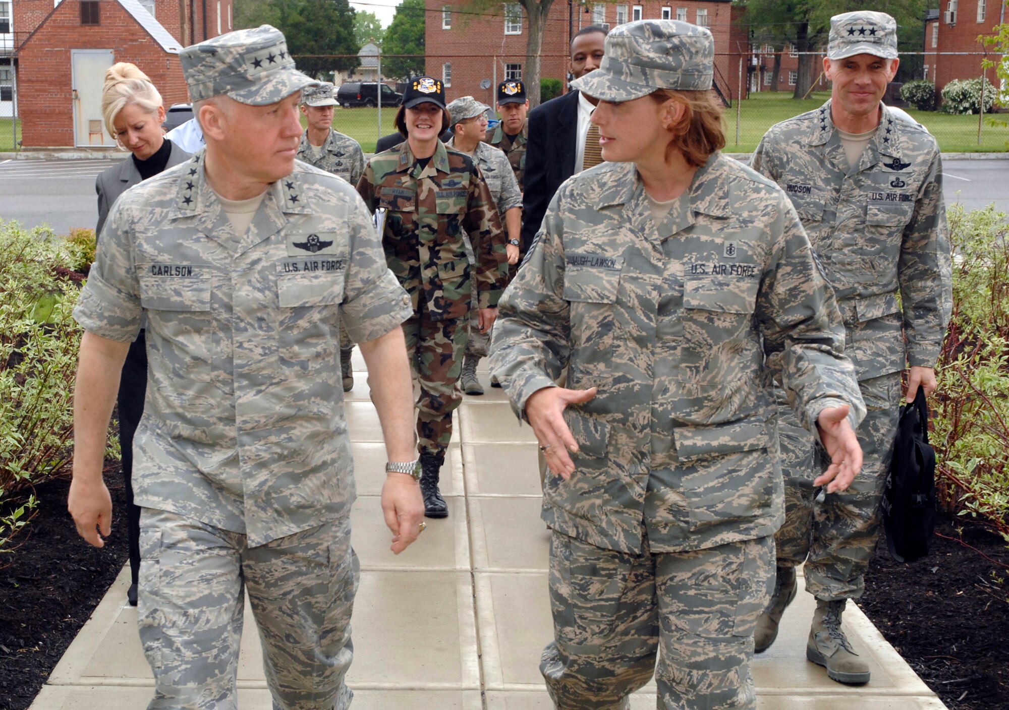 Tech. Sgt. Christy Cavanaugh-Lawson, dorm manager with the 88th Civil Engineer Directorate, briefs Gen. Bruce Carlson, Air Force Materiel Command commander, during a tour of Wright-Patterson Air Force Base dormitories.  Gen. Carlson observed 88th Air Base Wing missions and met Airmen and civilian employees across the installation May 8.  (U.S. Air Force photo/Al Bright)