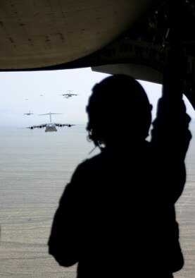 Master Sgt. Pete Moss, 57th Weapons Squadron loadmaster, looks out from the lead aircraft as they simulate airdropping cargo during the Mobility Air Forces Exercise May 9 over the Nevada Test and Training Range. (U.S. Air Force photo/Senior Airman Danielle Johnson)