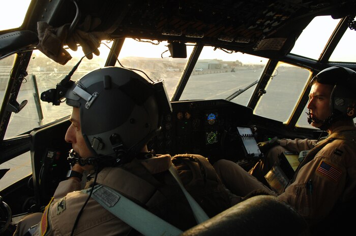 BALAD AIR BASE, Iraq -- Col. Donald Kimminau, 332nd Expeditionary Operations Group deputy commander, and Capt. Jesse Caldwell, 777th Expeditionary Airlift Squadron aircraft commander, look on as cargo is brought up to the aircraft for loading in Southwest Asia, May 7. The 777 EAS personnel estimate they have prevented approximately 10,000 convoy vehicles and about 27,000 servicemembers from traveling along improvised explosive device laden Iraqi roads since the squadron stood up in January 2006. This was accomplished by providing air transport via C-130 aircraft, the 'work horse' of the Air Force fleet. Colonel Kimminau is deployed from Maxwell Air Force Base, Ala., and Captain Caldwell is deployed from Little Rock Air Force Base, Ark. (U.S. Air Force photo/ Senior Airman Julianne Showalter)