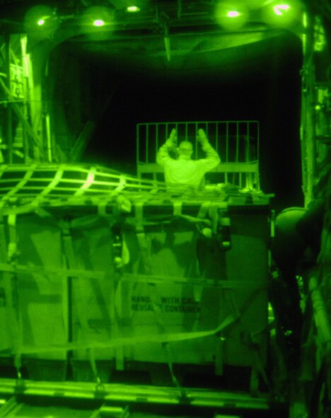 BALAD AIR BASE, Iraq -- Staff Sgt. Ronnie James, 777th Expeditionary Airlift Squadron loadmaster, ushers a pallet of cargo into a C-130 Hercules during a combat mission in Southwest Asia, May 7. The 777 EAS personnel estimate they have prevented approximately 10,000 convoy vehicles and about 27,000 servicemembers from traveling along improvised explosive device laden Iraqi roads since the squadron stood up in January 2006. This was accomplished by providing air transport via C-130 aircraft, the 'work horse' of the Air Force fleet. Sergeant James is deployed from Little Rock Air Force Base, Ark. (U.S. Air Force photo/ Senior Airman Julianne Showalter)