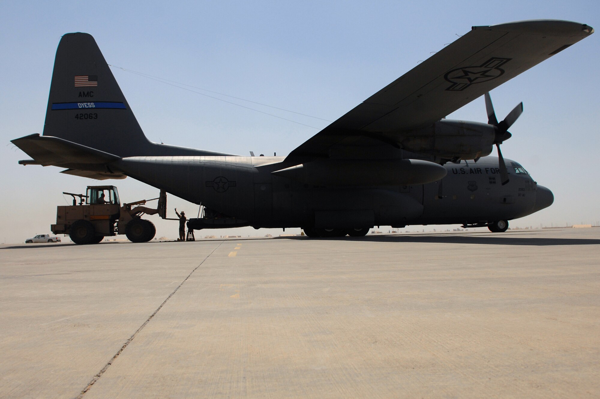 BALAD AIR BASE, Iraq --Cargo is loaded onto a C-130 Hercules here, May 10. The 777th Expeditionary Airlift Squadron personnel estimate they have prevented approximately 10,000 convoy vehicles and about 27,000 servicemembers from traveling along improvised explosive device laden Iraqi roads since the squadron stood up in January 2006. This was accomplished by providing air transport via C-130 aircraft, the 'work horse' of the Air Force fleet. (U.S. Air Force photo/ Senior Airman Julianne Showalter)