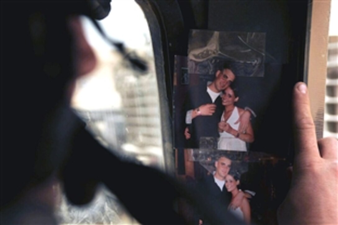 U.S. Army Sgt. Steven Lewis of Oklahoma City, Okla., looks at a picture of his girlfriend before leaving on patrol in Sadr City, Baghdad, Iraq, May 6, 2008. Lewis is assigned to 4th Infantry Division, 3rd Battalion Combat Team. 
